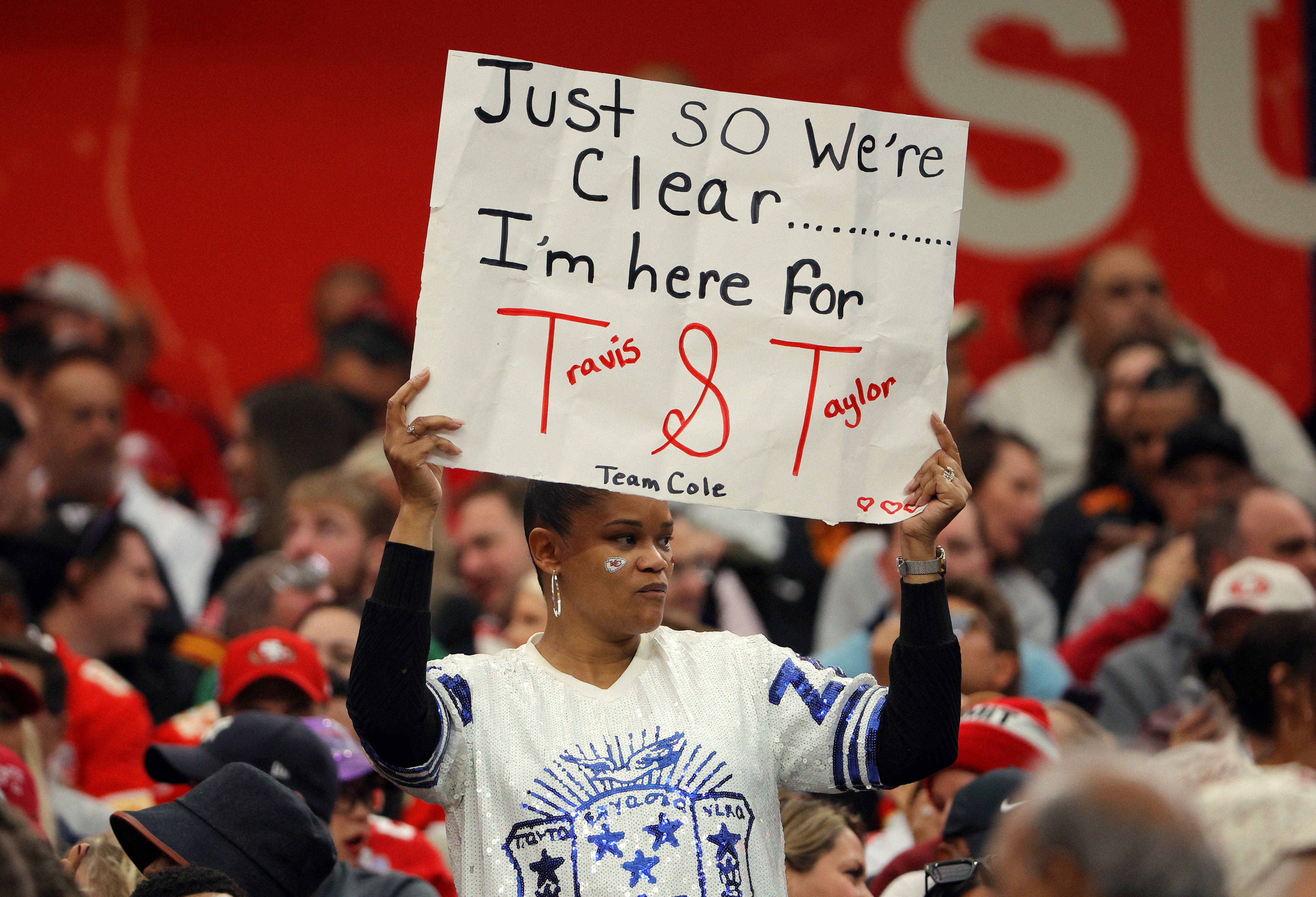 Football - NFL - Super Bowl LVIII - Kansas City Chiefs v San Francisco 49ers - Allegiant Stadium, Las Vegas, Nevada, United States - February 11, 2024 A fan displays a sign in reference to Kansas City Chiefs' Travis Kelce and Taylor Swift before the game 