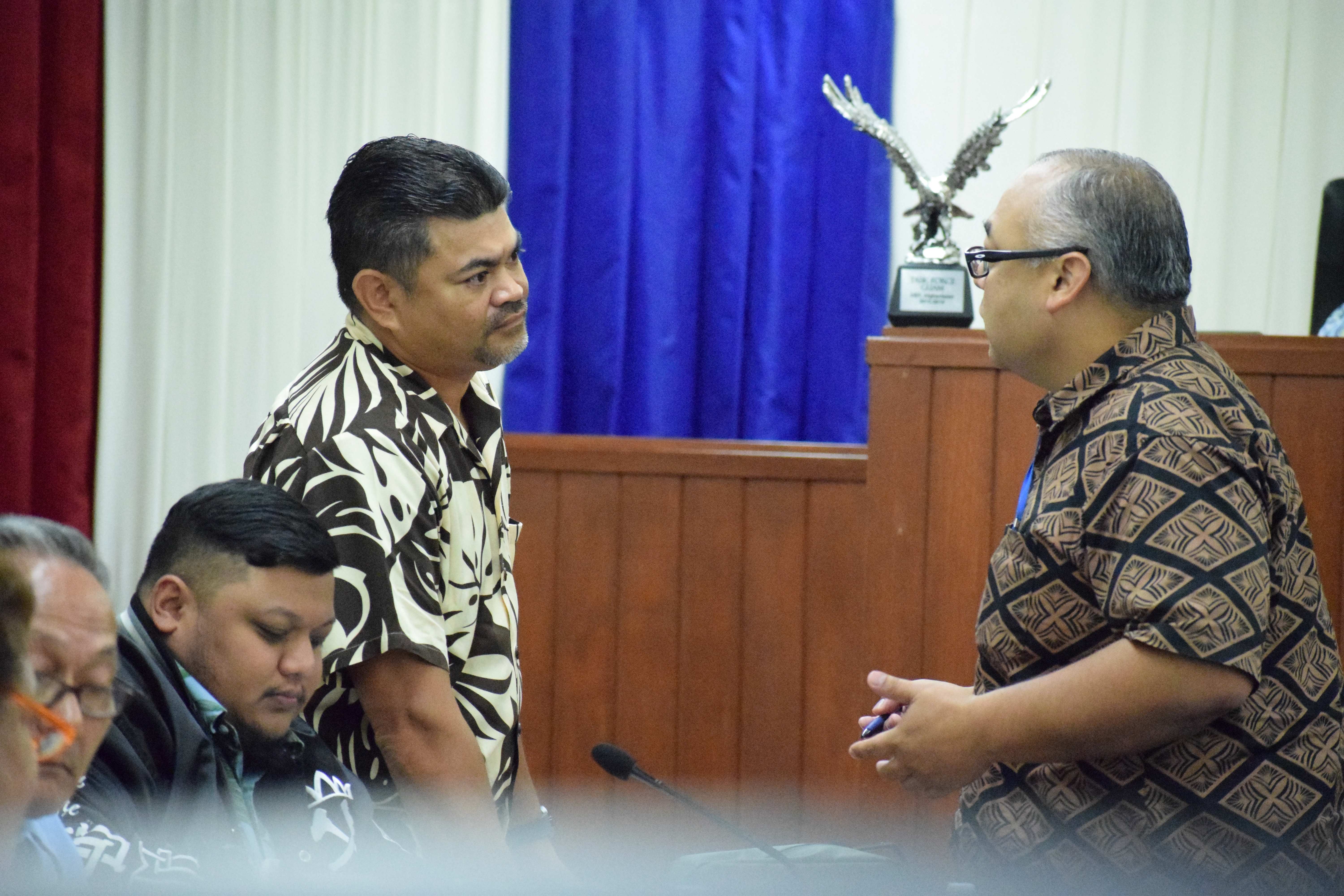 Reps. Roy Ada, left, listens to  Rep. Blas Jonathan Attao during a break from a session of the Saipan and Northern Islands Legislative Delegation in the House chamber on Wednesday. Also in photo are Reps. Thomas John Manglona and Vicente Camacho, seated.