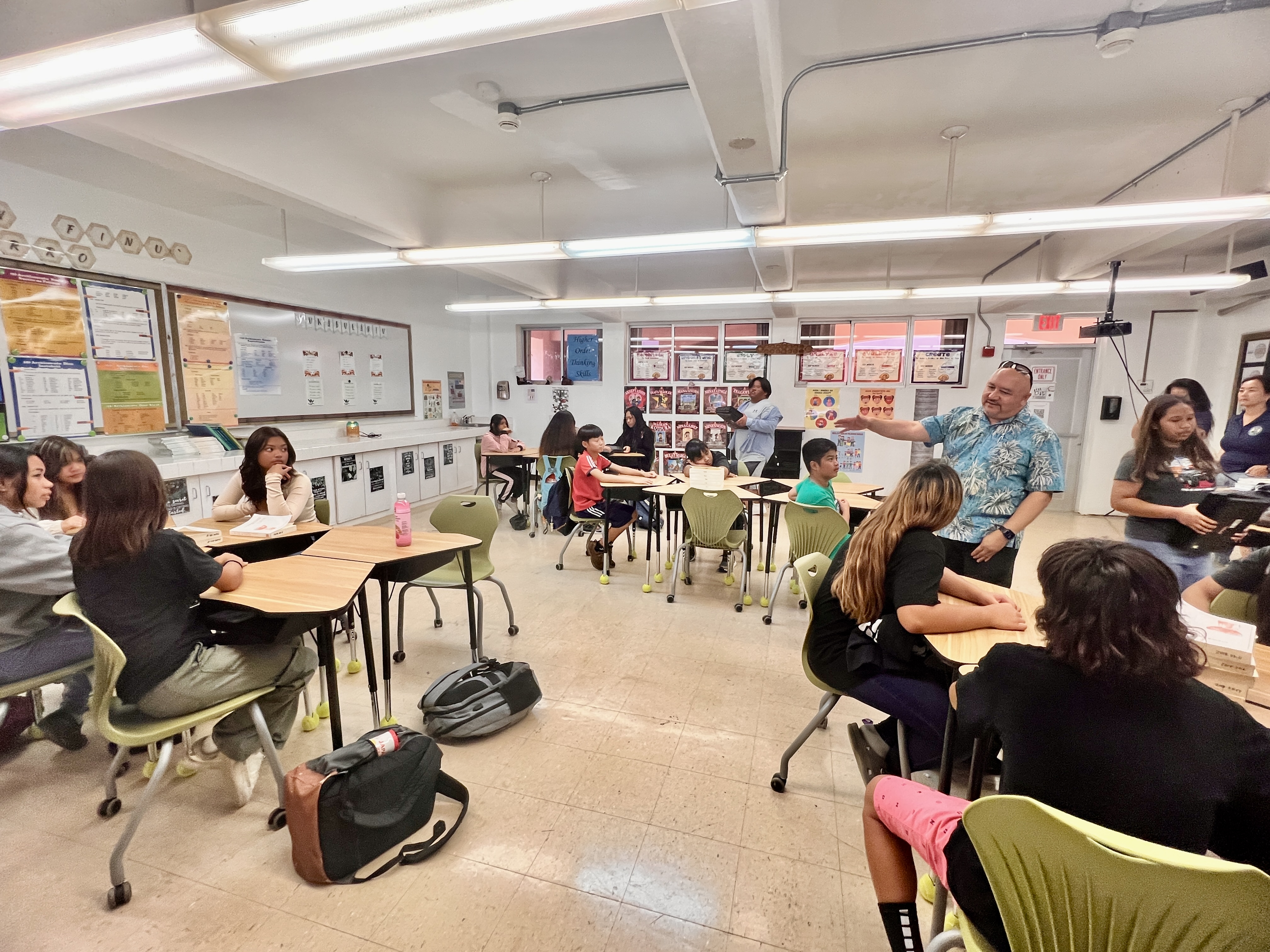 Dr. Lawrence F. Camacho, the commissioner of education, talks with students of an immersion class at Tinian Middle School.