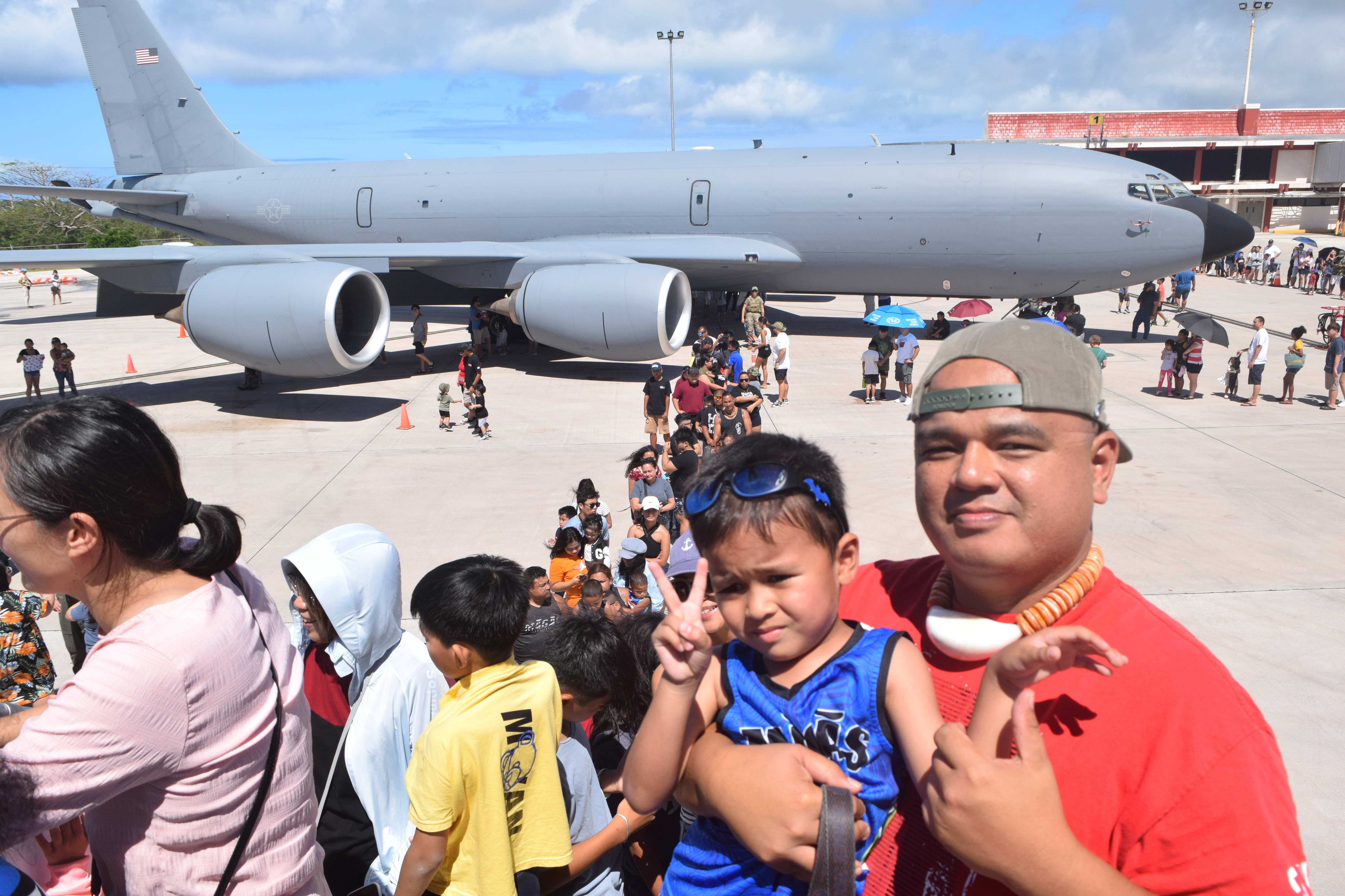 Civil Service Commission Chair Ray Muna and son Ryu wait for their turn to enter the KC-135.