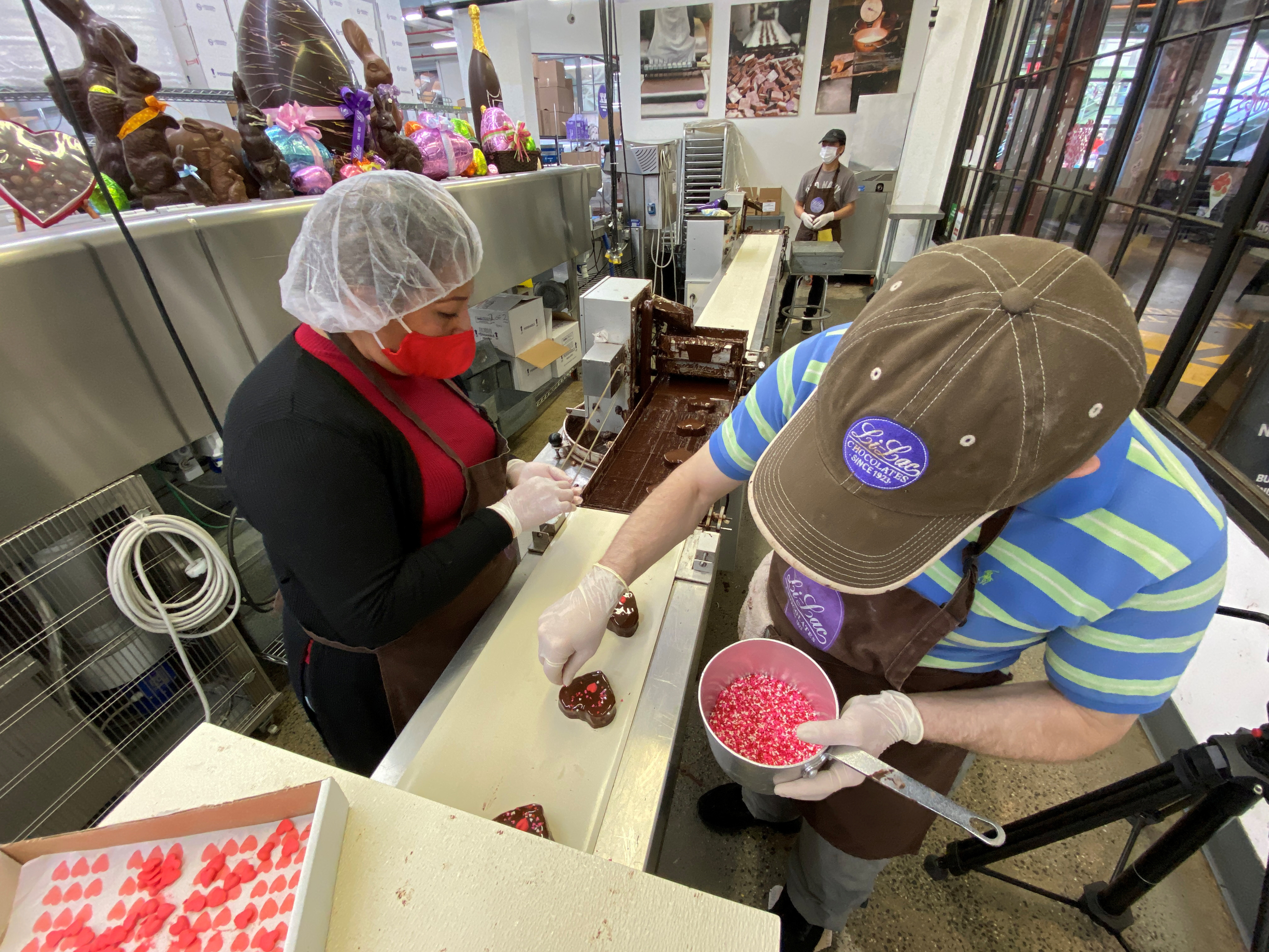 Workers process sweets at Li-Lac Chocolates in the Brooklyn borough of New York City, U.S. February 11, 2022. 
