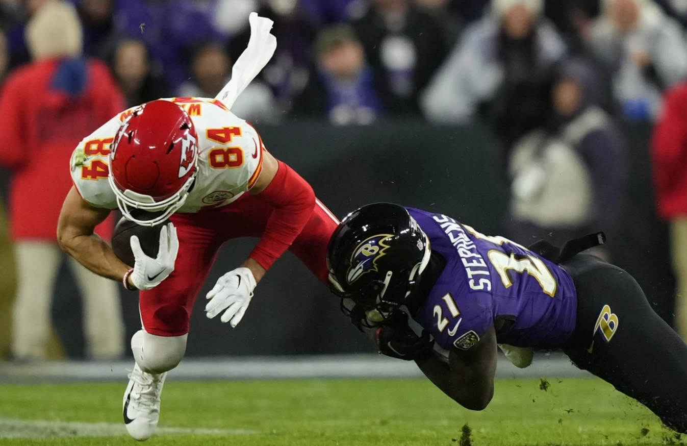 Kansas City Chiefs wide receiver Justin Watson (84) is tackled by Baltimore Ravens cornerback Brandon Stephens (21) during the second half of the AFC championship NFL game, Sunday, Jan. 28, 2024 in Baltimore.