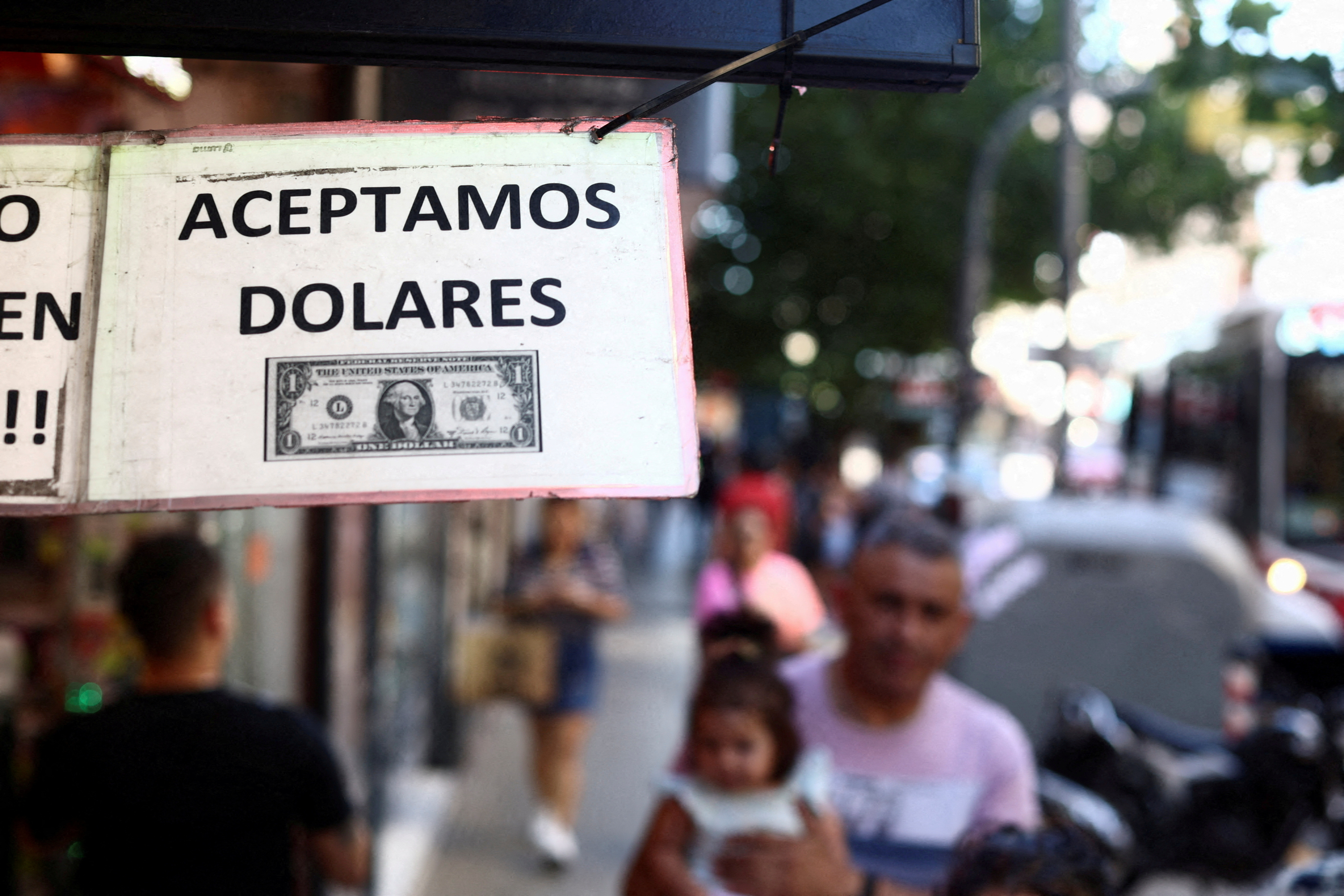 A sign outside a store reads in Spanish "We accept Dollars" in Buenos Aires, Argentina, December 12, 2023. 