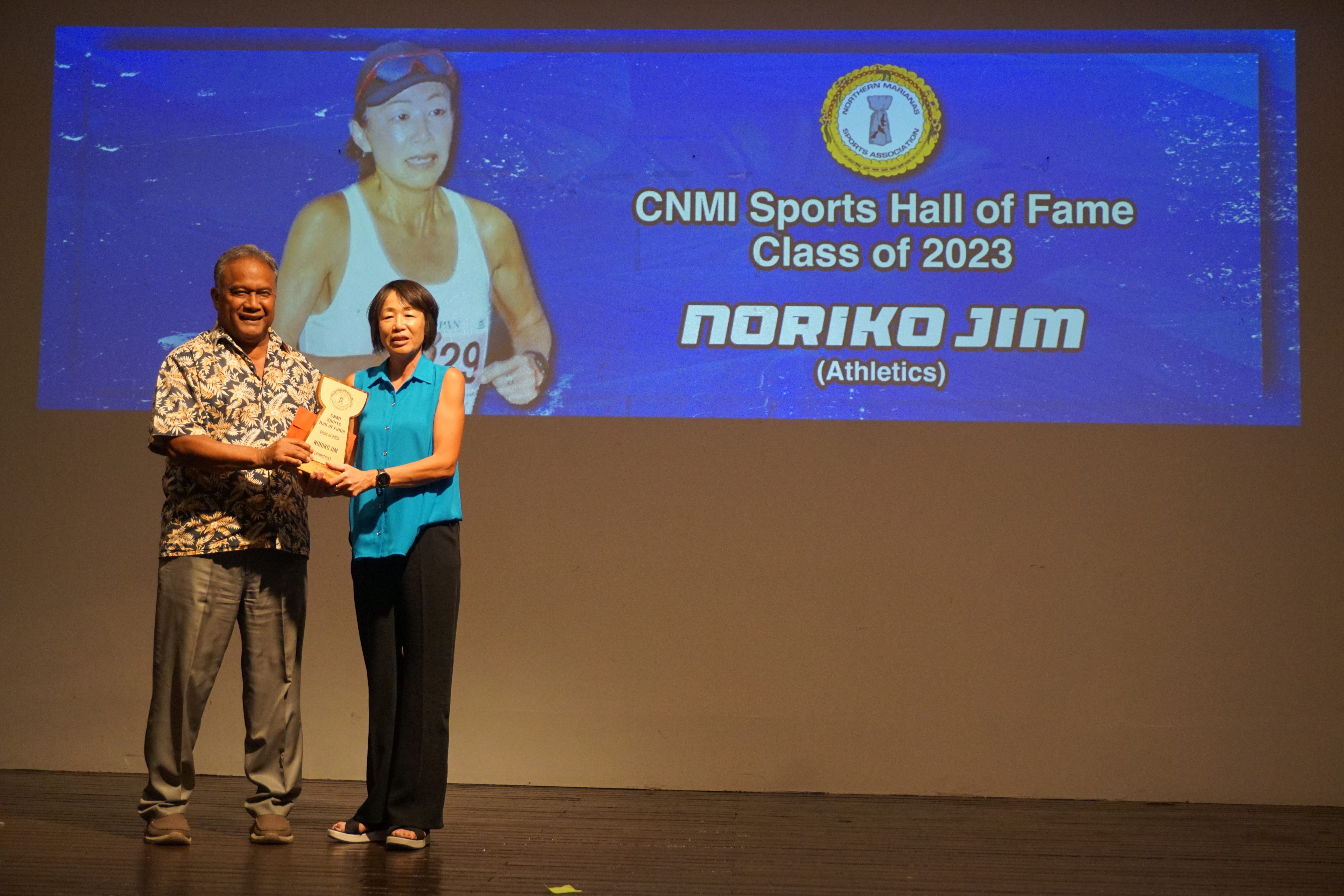 Noriko Jim holds the CNMI Sports Hall of Fame trophy as she poses for a photo with Northern Marianas Athletics president Ray Tebuteb during the Northern Marianas Sports Association Annual Awards Banquet at the Hibiscus Hall of the Crowne Plaza Resort Saipan on Wednesday evening.