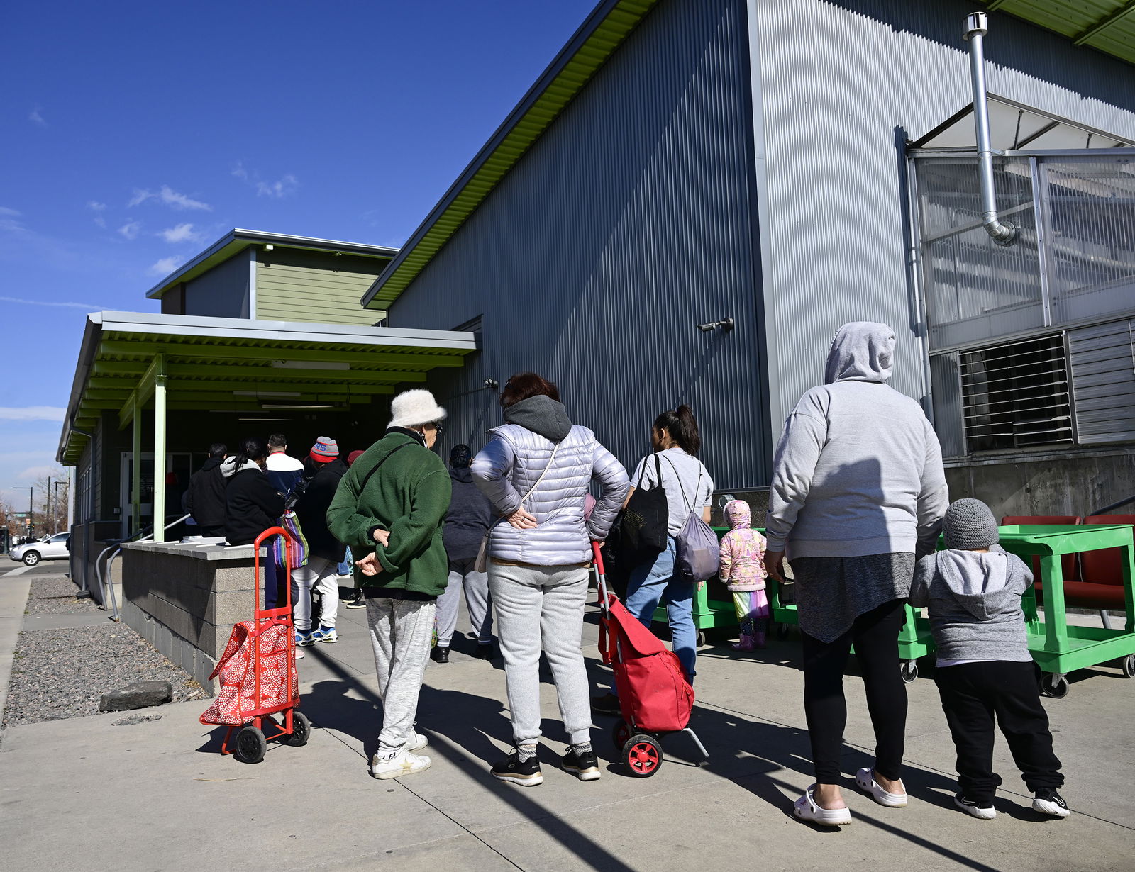 People line up outside the Metro Caring Food Bank in Denver on Thursday, Feb. 15, 2024. The pantry has had to suspend its emergency food bags in the face of increased demand. (Andy Cross/The Denver Post/TNS)
