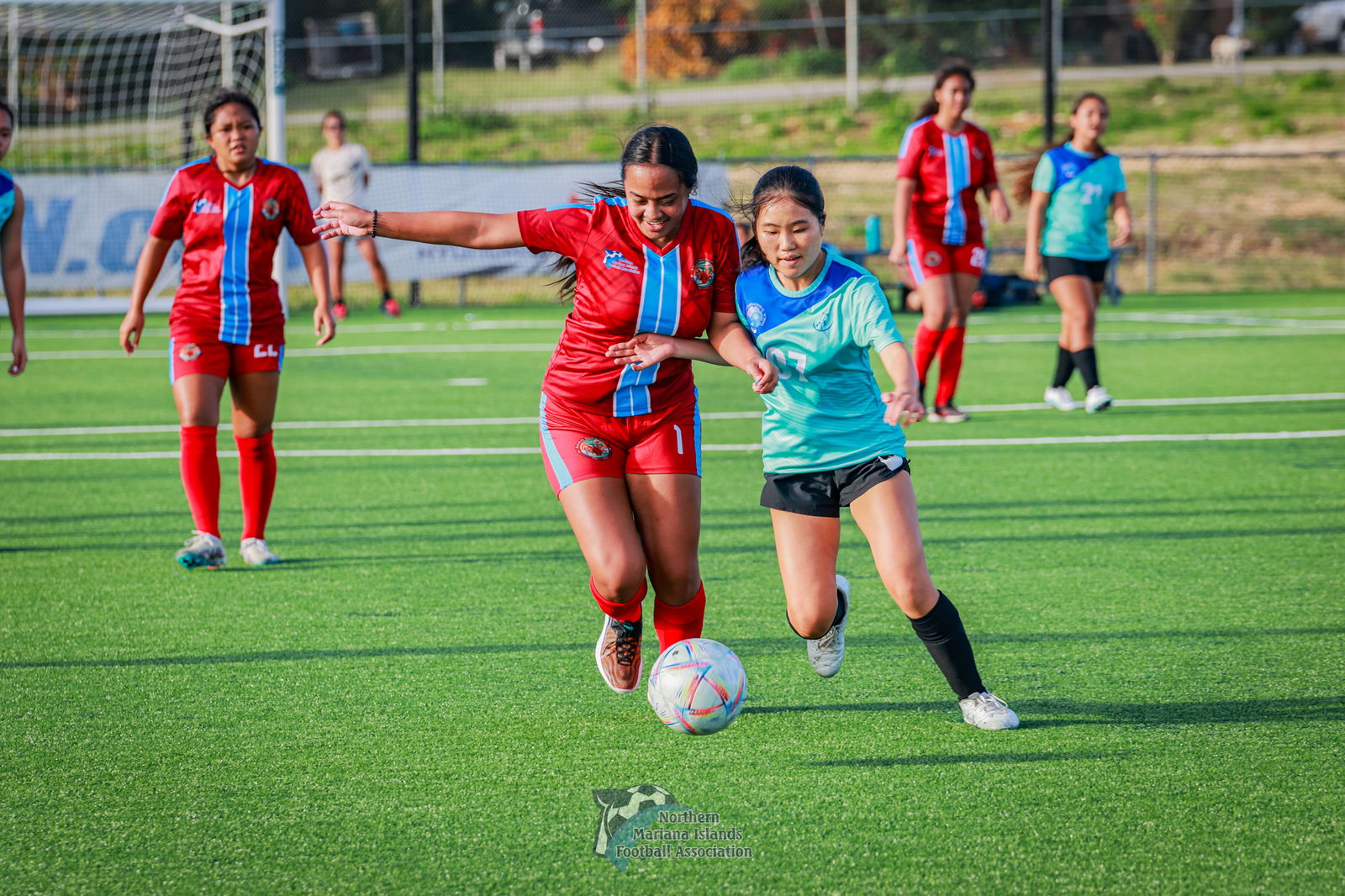 Serin Chung of SIS battles for control against KHS' Hiram Albrina during a girls high school division game of the NMIFA-PSS Interscholastic Soccer League SY23-24 at the NMI Soccer Training Center in Koblerville.