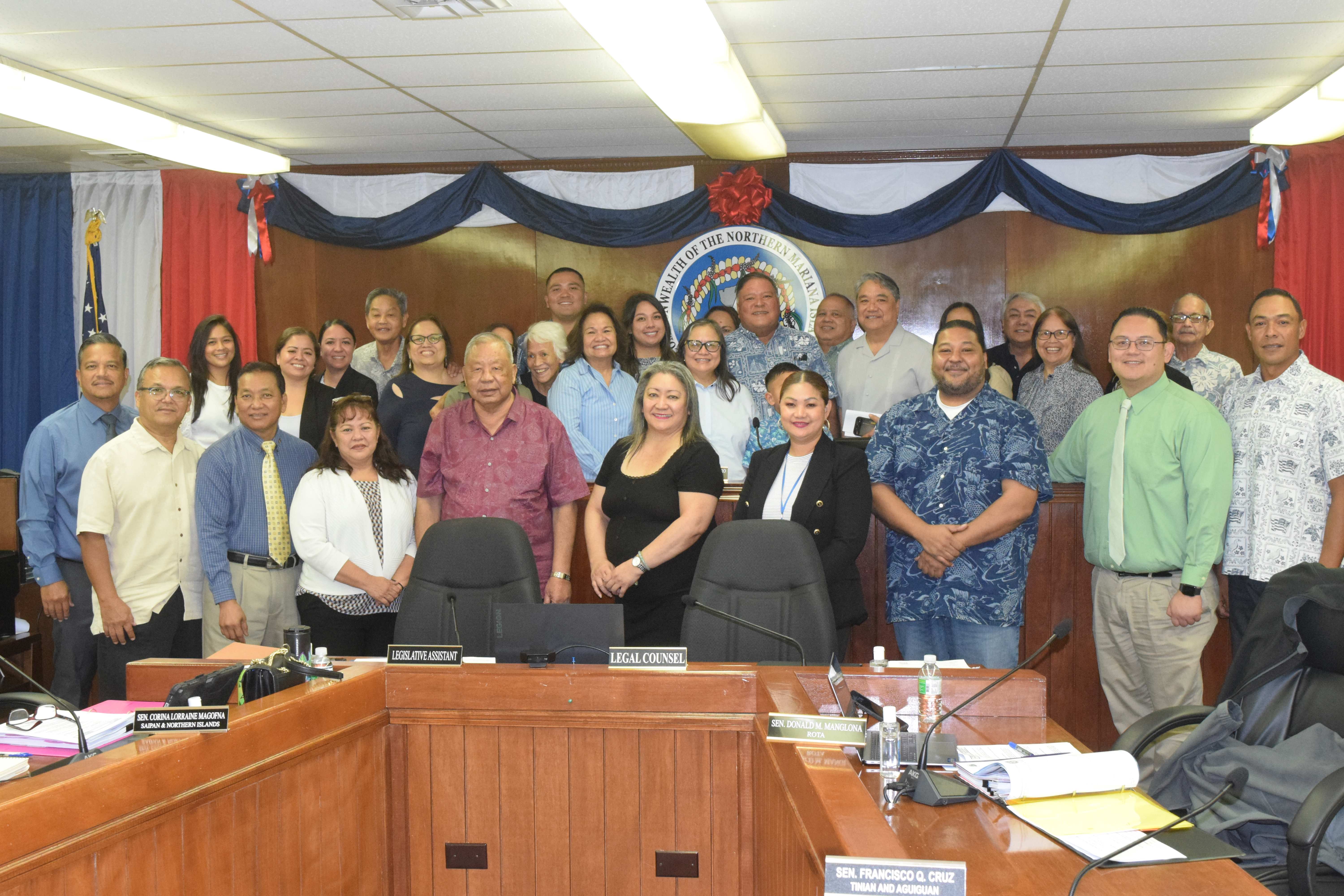 Deputy Attorney General Lilian Tenorio, center, poses for a photo with senators, her family and friends after the Senate confirmed her nomination on Tuesday.