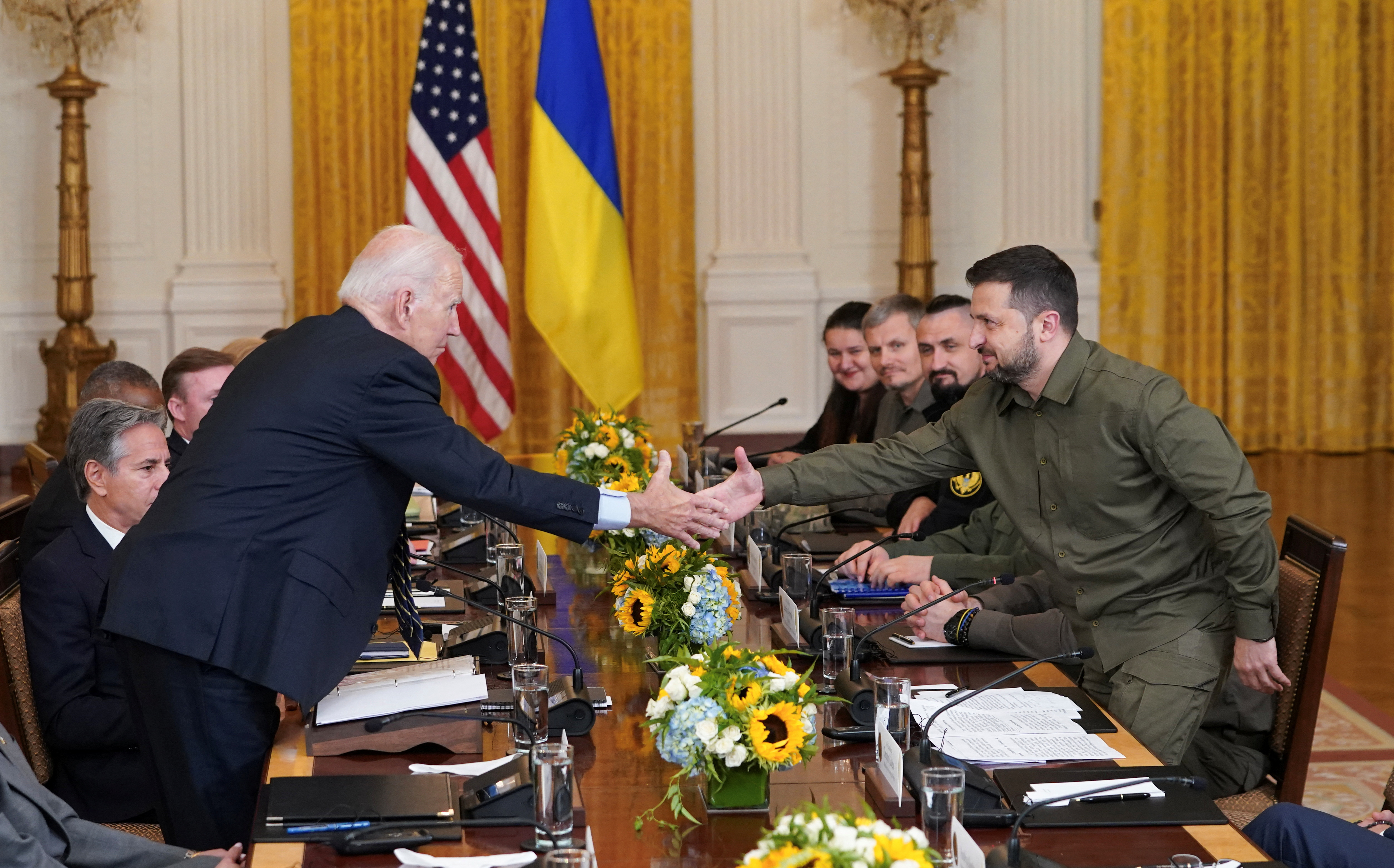 U.S. President Joe Biden and Ukraine President Volodymyr Zelenskiy shake hands across the table during a meeting in the East Room of the White House in Washington, U.S. September 21, 2023. 
