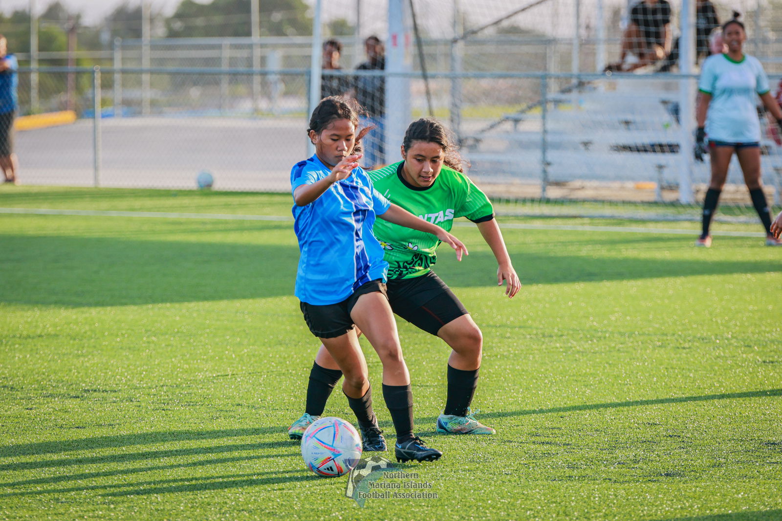 MHS' Kaye Costales protects the possession against SSHS' Rosie Saralu during a girls high school division game of the NMIFA-PSS Interscholastic Soccer League SY23-24 at the NMI Soccer Training Center in Koblerville.