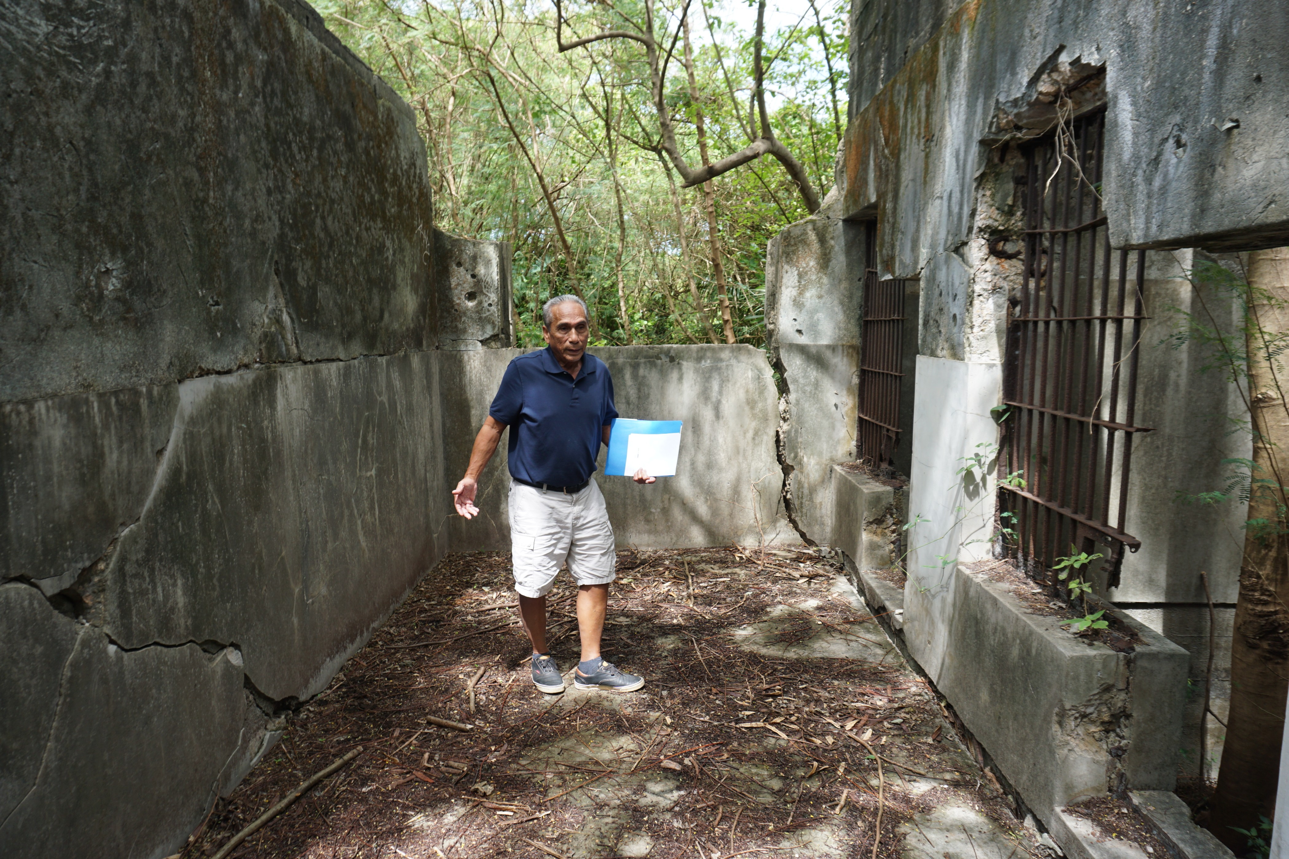 Ernesto C. Arriola stands near some of the cells at the old Japanese jail. Some local residents believe that Amelia Earhart was imprisoned and died on Saipan. 