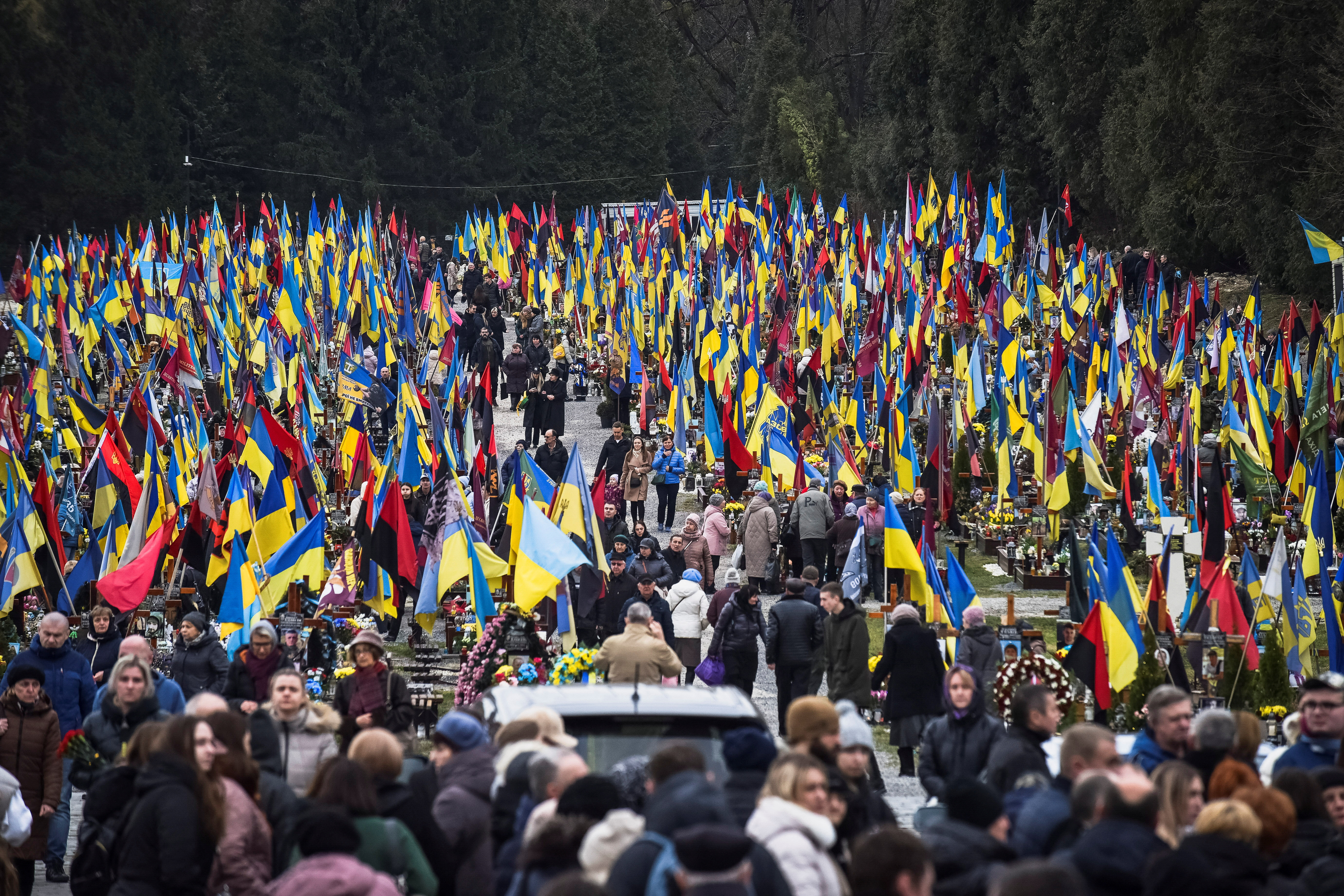 People visit graves of their relatives, killed Ukrainian defenders, on a day of the second anniversary of Russia's attack on Ukraine, in Lviv, Ukraine February 24, 2024. 