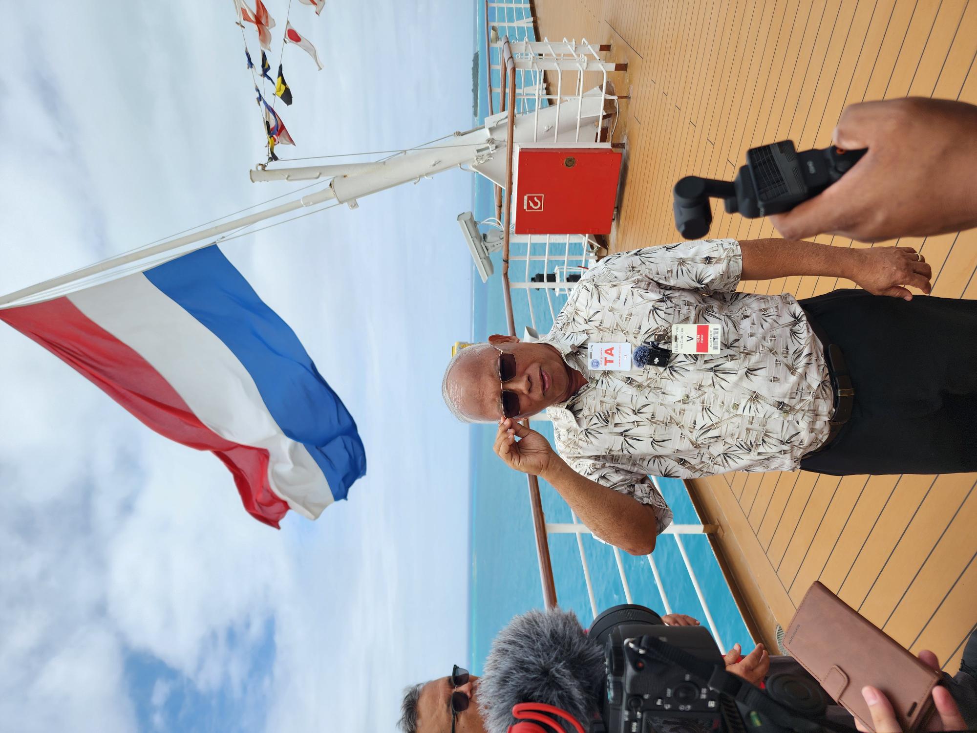 Commonwealth Ports Authority Board Chair Jose Ayuyu talks to reporters  aboard the MS Zuiderdam on Monday.