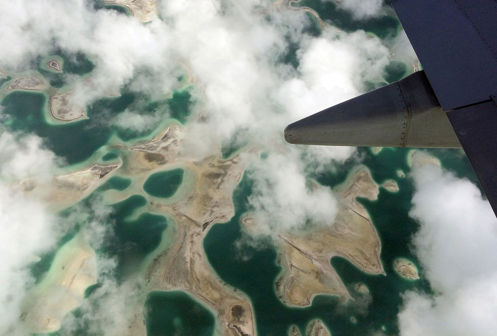 FILE PHOTO: Lagoons can be seen from a plane as it flies above Kiritimati Island, part of the Pacific Island nation of Kiribati, April 5, 2016. 