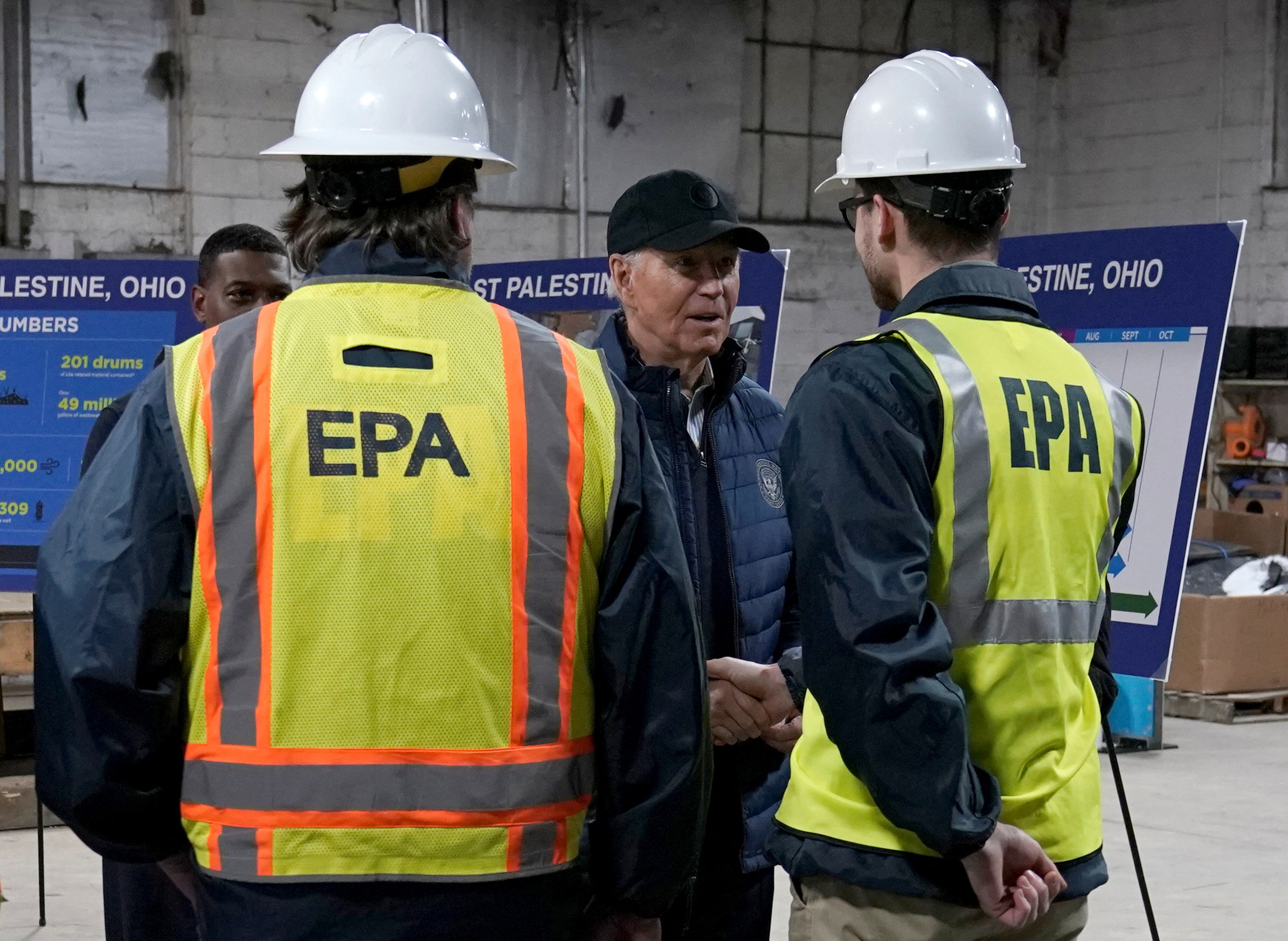U.S. President Joe Biden speaks with Environmental Protection Agency workers during his visit to East Palestine for the first time since a fiery derailment of a Norfolk Southern train a year ago released more than a million gallons of hazardous materials and pollutants, in East Palestine, Ohio, U.S., February 16, 2024. 