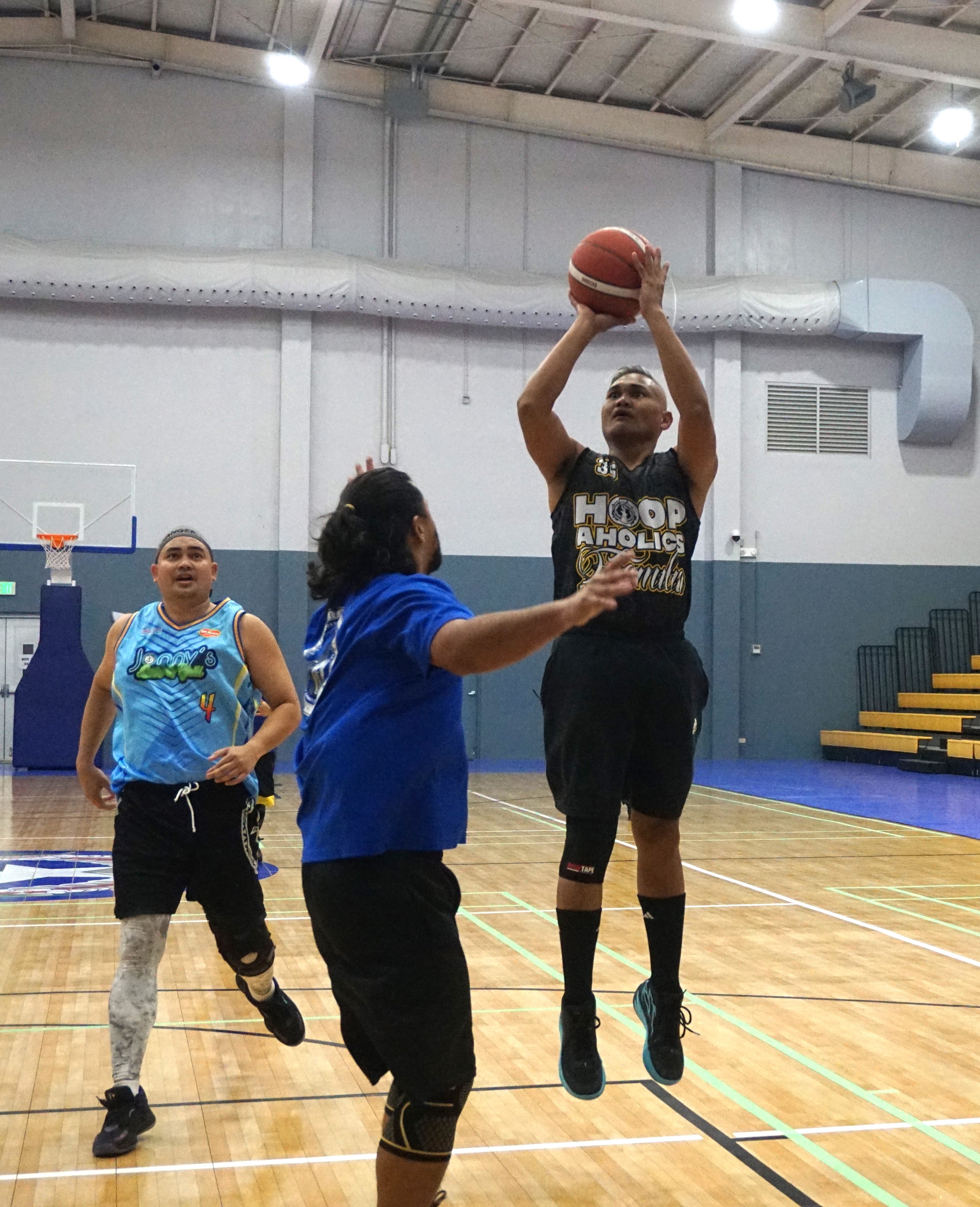 Hoopaholics 670's Walter Mendez pulls up for the mid-range jumper over a defender during a Masters "Internal" Basketball League game at the Ada gym on Saturday.
