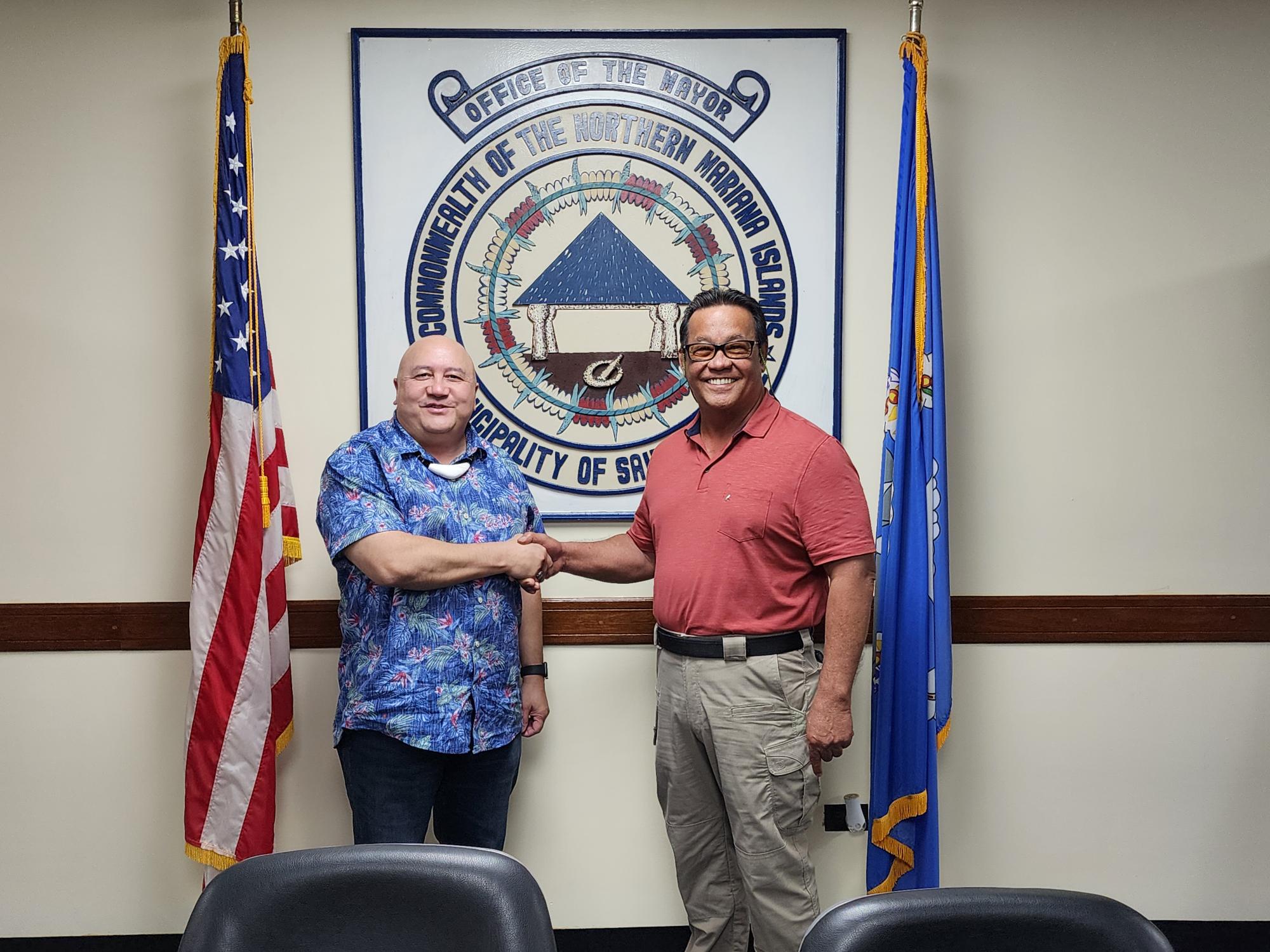 Education Commissioner Lawrence Camacho, left, shakes hands with Saipan Mayor Ramon “RB” Camacho after a meeting on Wednesday.