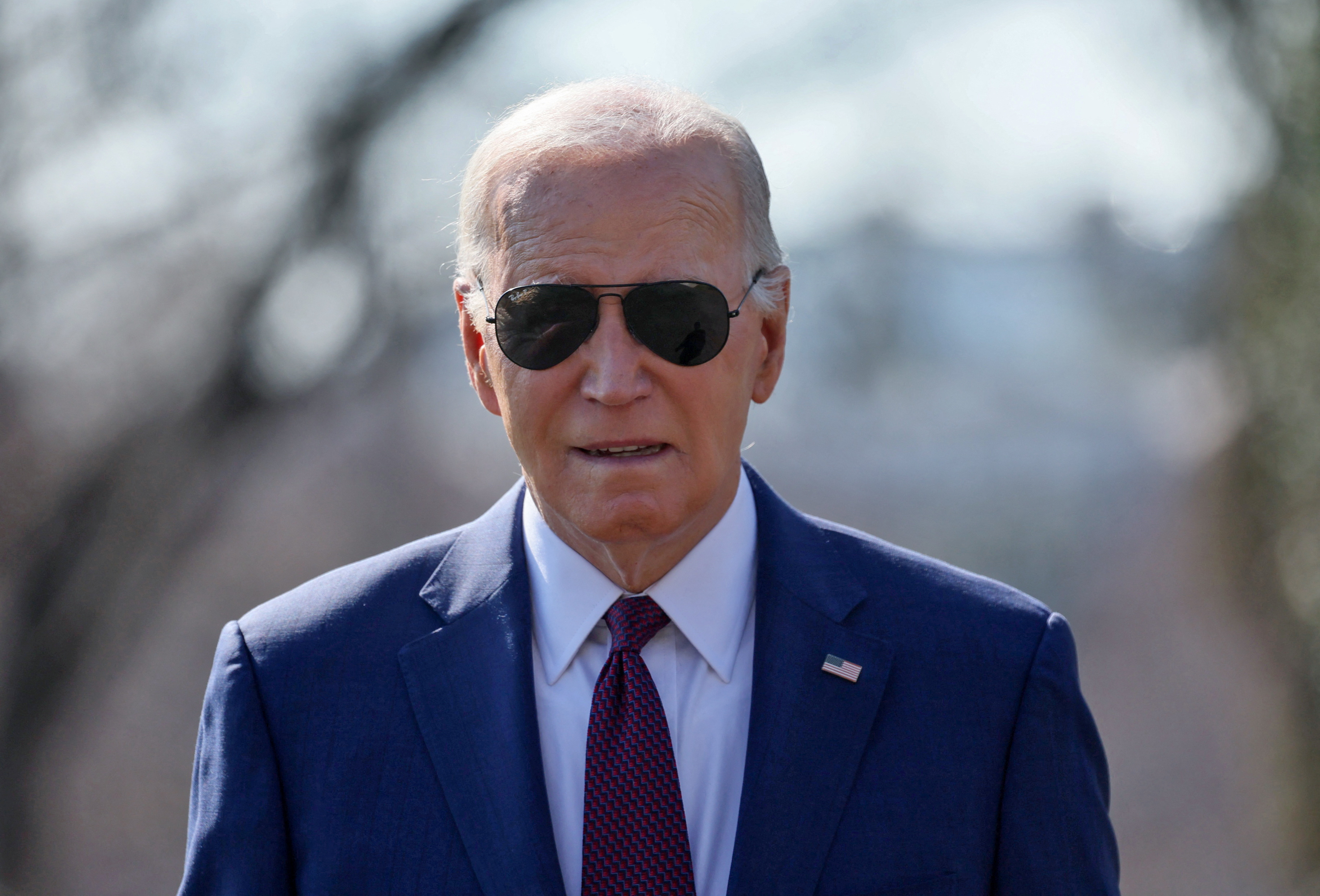 U.S. President Joe Biden walks up to members of the news media to give a statement before boarding Marine One for travel to California from the South Lawn of the White House in Washington, U.S., February 20, 2024. 