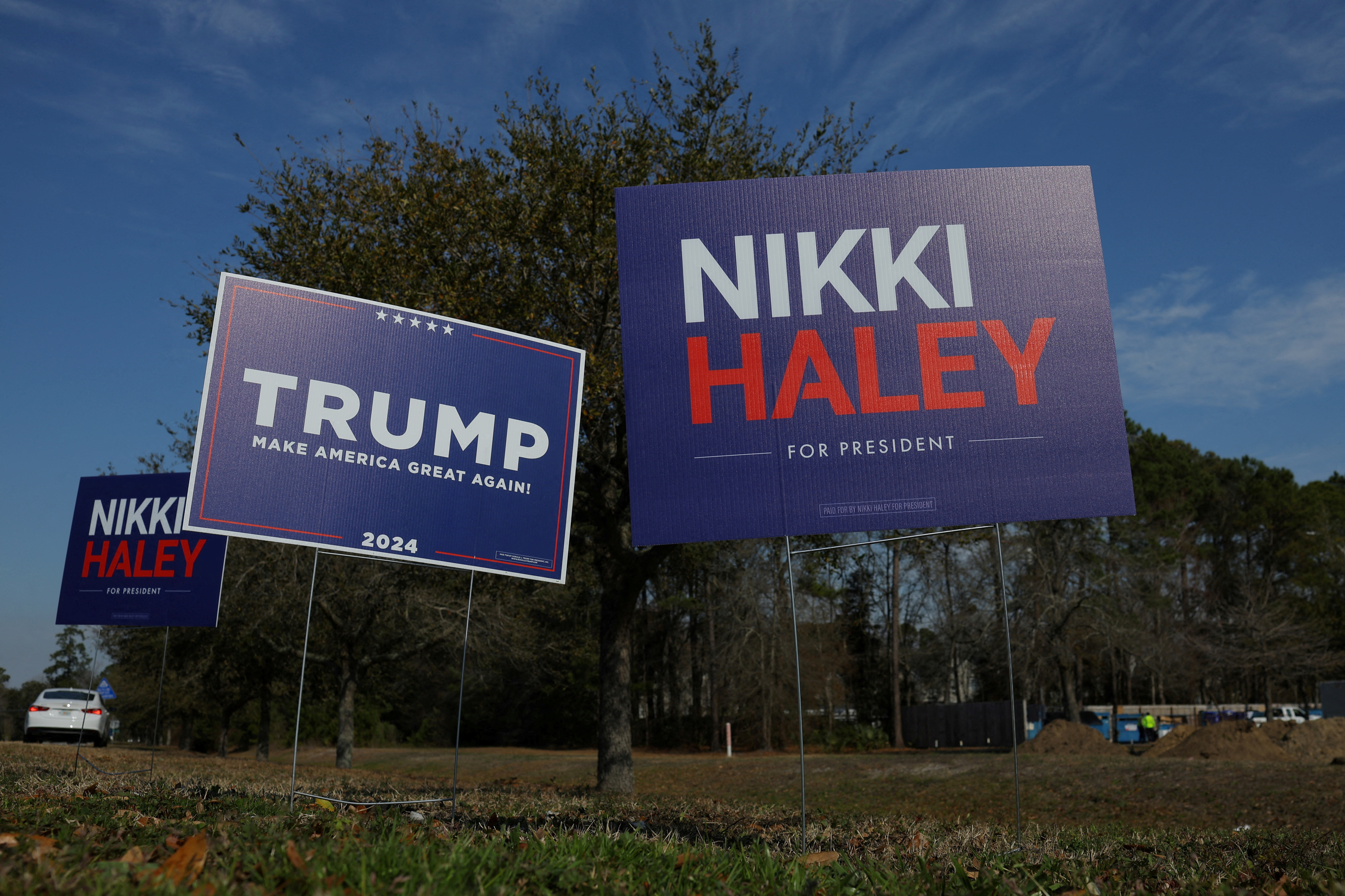 FILE PHOTO: Campaign signs for Republican presidential candidates former U.S. Ambassador to the United Nations Nikki Haley and former U.S. President Donald Trump stand along an intersection in Mount Pleasant, South Carolina, U.S., February 22, 2024. 
