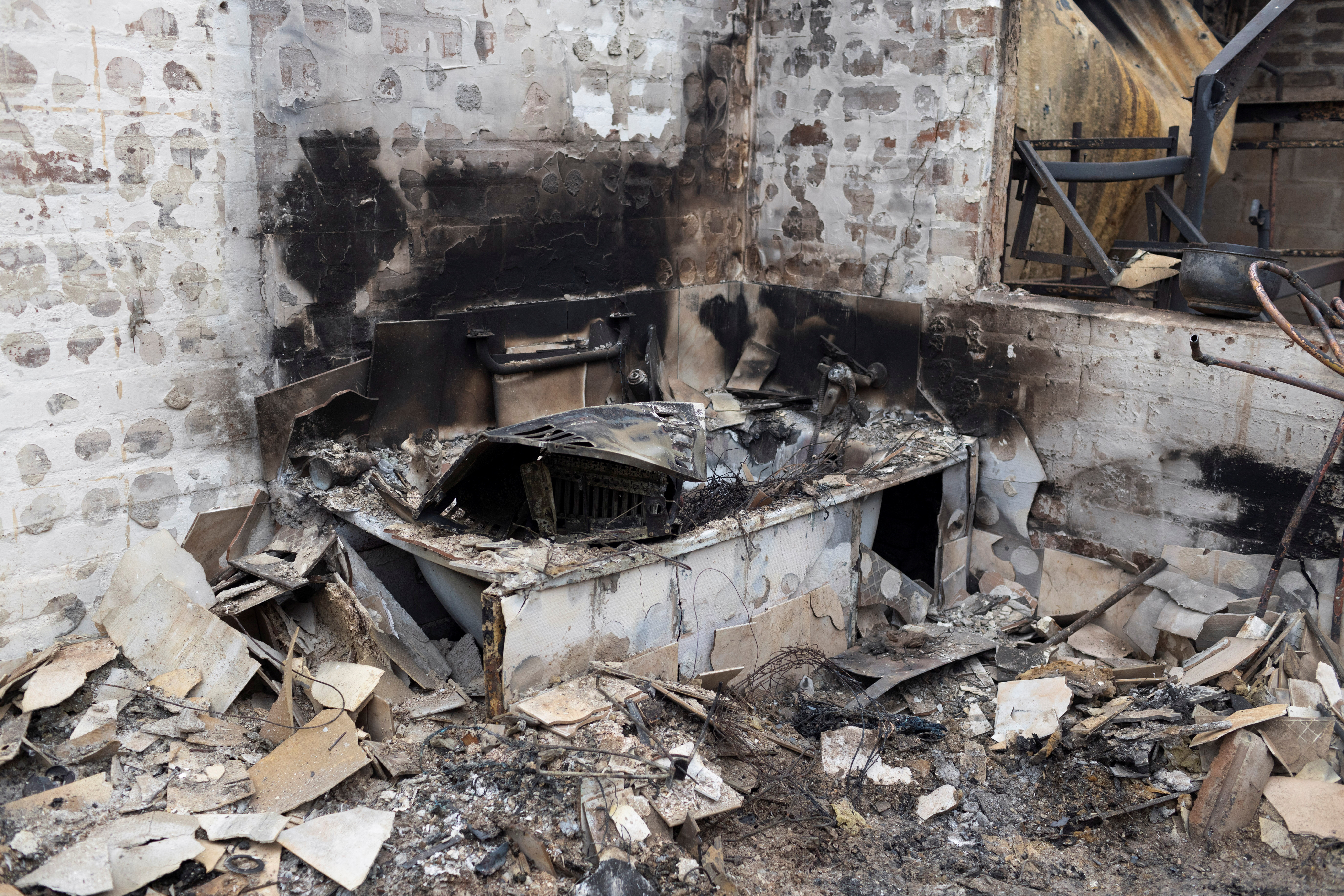 Debris covers the floor on the remains of a burned house, following the spread of wildfires in Vina del Mar, Chile, February 4, 2024. 