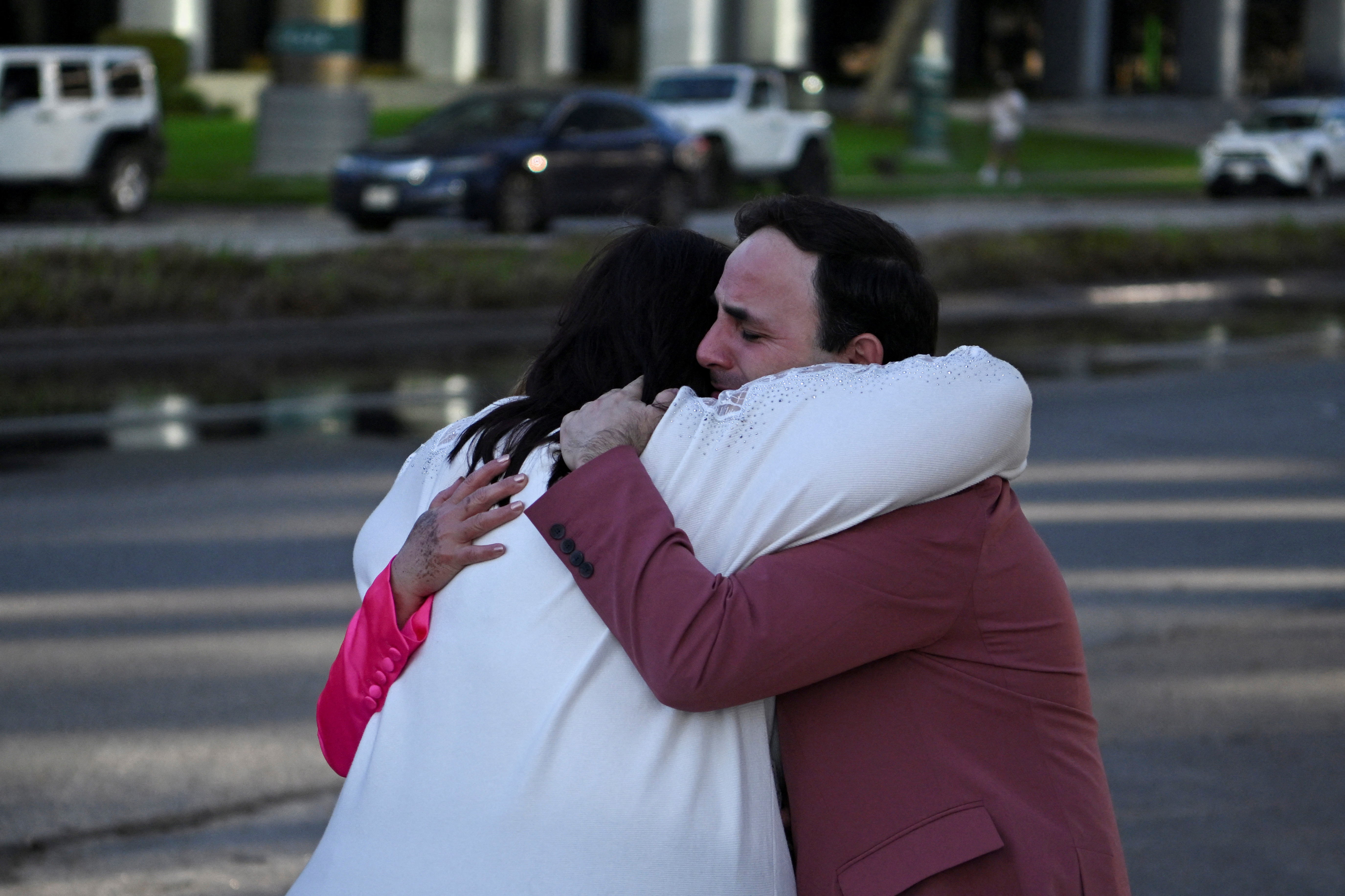 Carlos Gonzalez, a worship singer, hugs a fellow churchgoer after a shooting incident at television evangelist Joel Osteen's Lakewood Church in Houston, Texas, U.S. February 11, 2024. 