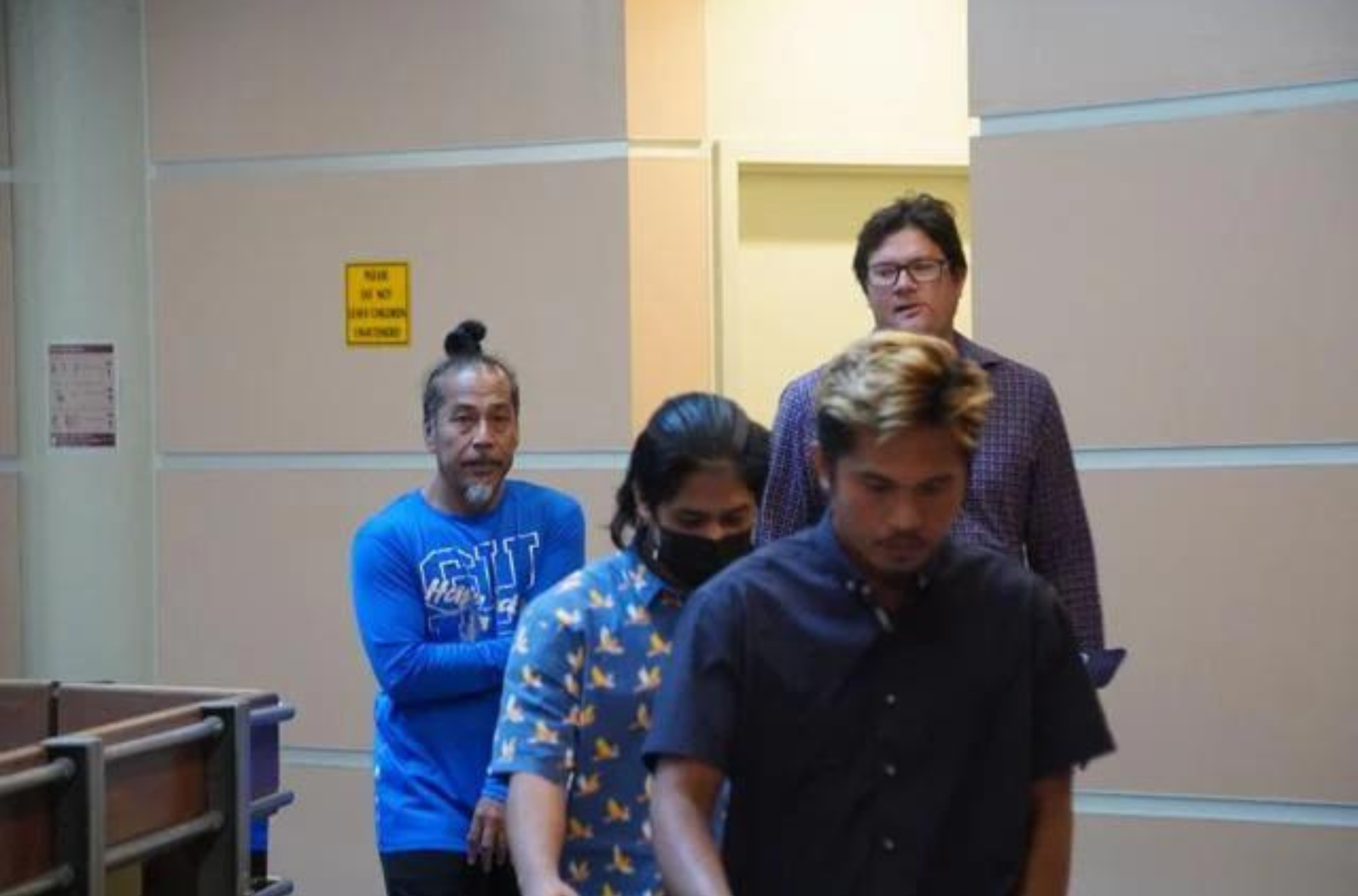 From left, Cyrus Mathias, Dero Isty, attorney Anthony Perez and L-Son Joe, foreground, walk out of the courtroom Friday, May 5, 2023, at the Guam Judicial Center in Hagåtña. 