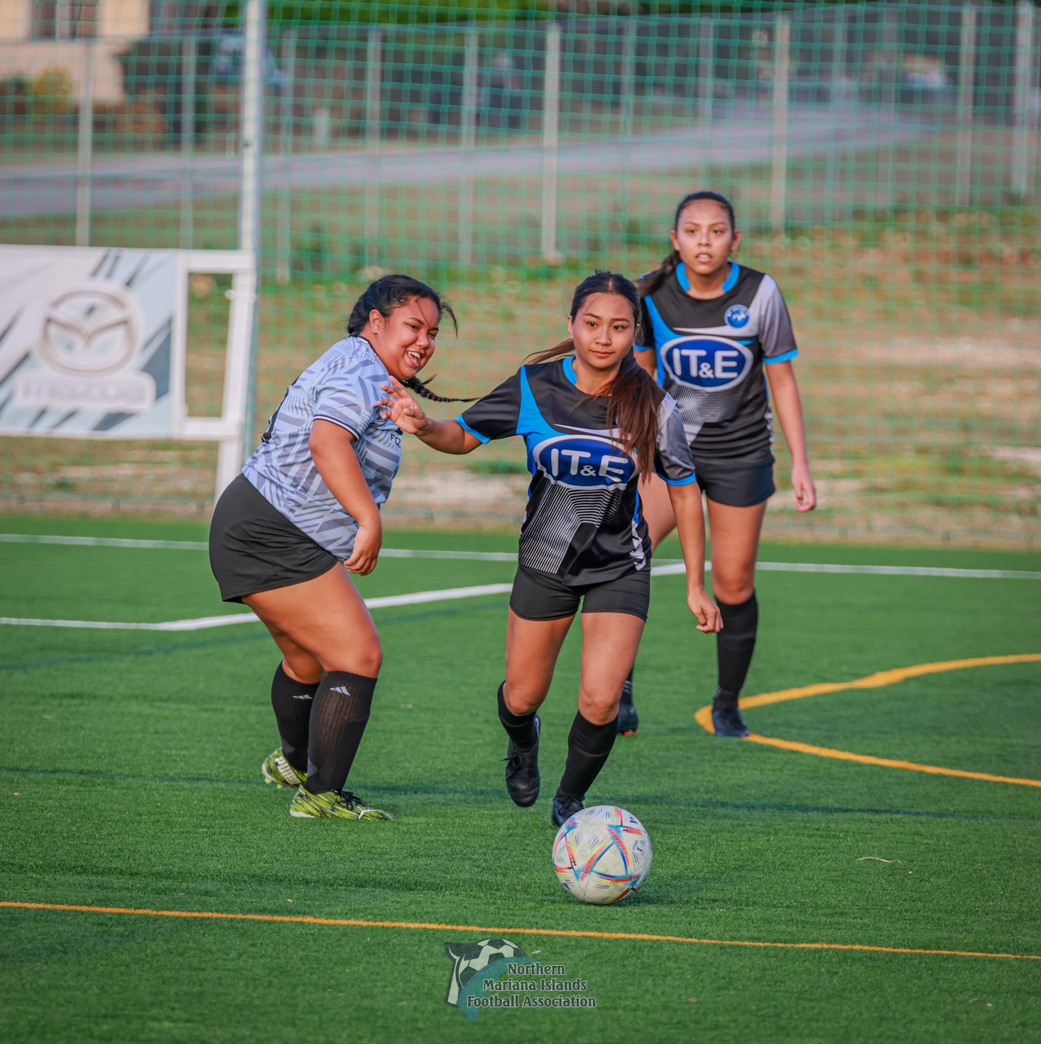 MPU Pink's Kimberly Palacios pushes forward after slipping past a Latte FC defender during a novice division game of the Dove Women's League 2024 at the NMI Soccer Training Center in Koblerville on Sunday. 