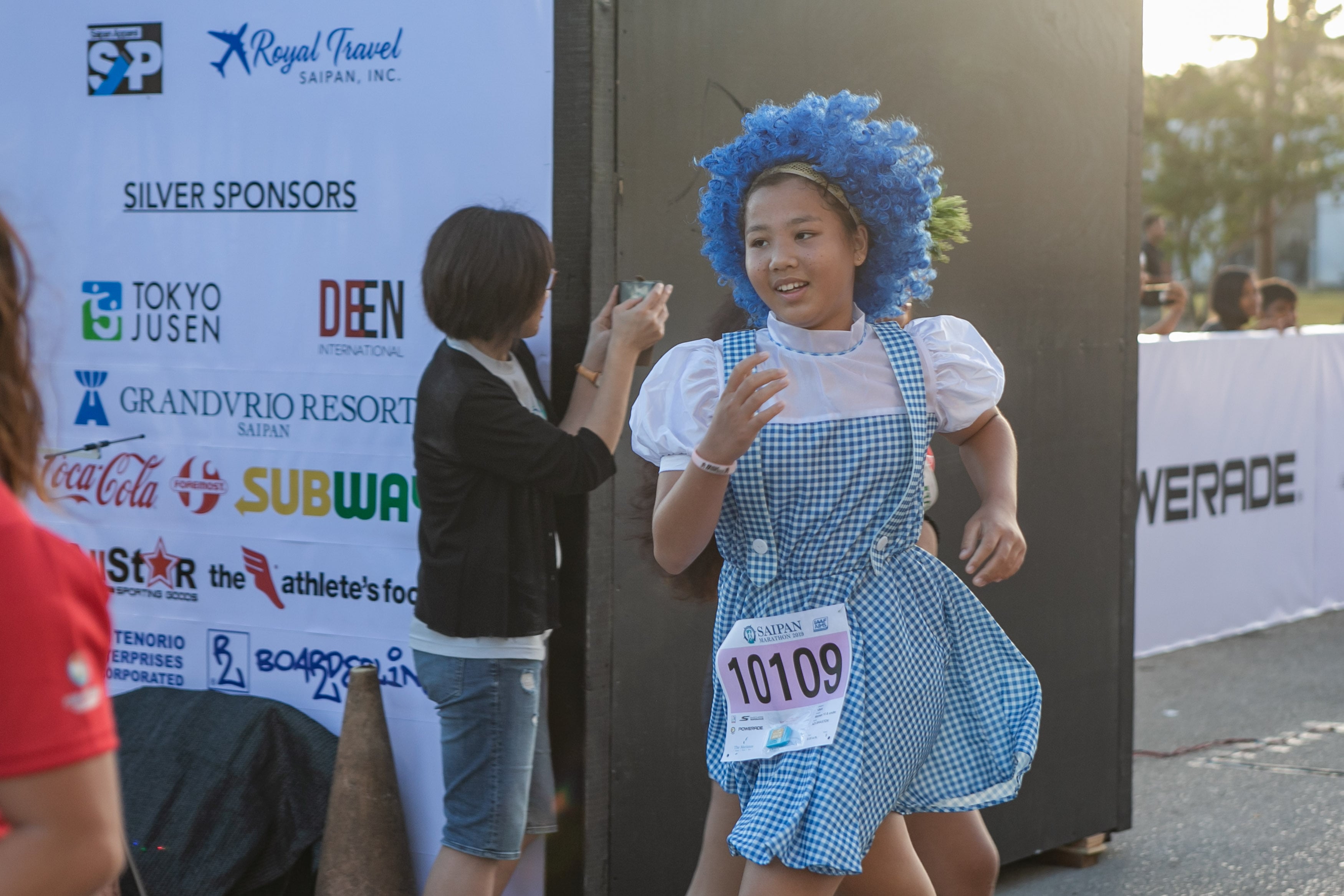 A participant in a wacky costume heads to the finish line of the Saipan Marathon in this file photo.