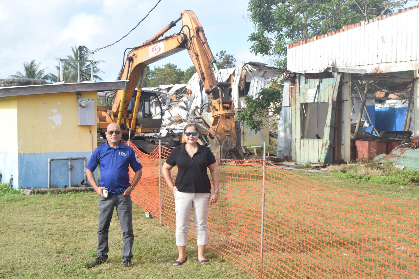 Acting Education Commissioner Donna M. Flores, right, and Public School System Facilities Development and Management's Rommel Mostales stand near a demolition site at Admiral Herbert G. Hopwood Middle School in Chalan Piao on Saturday.