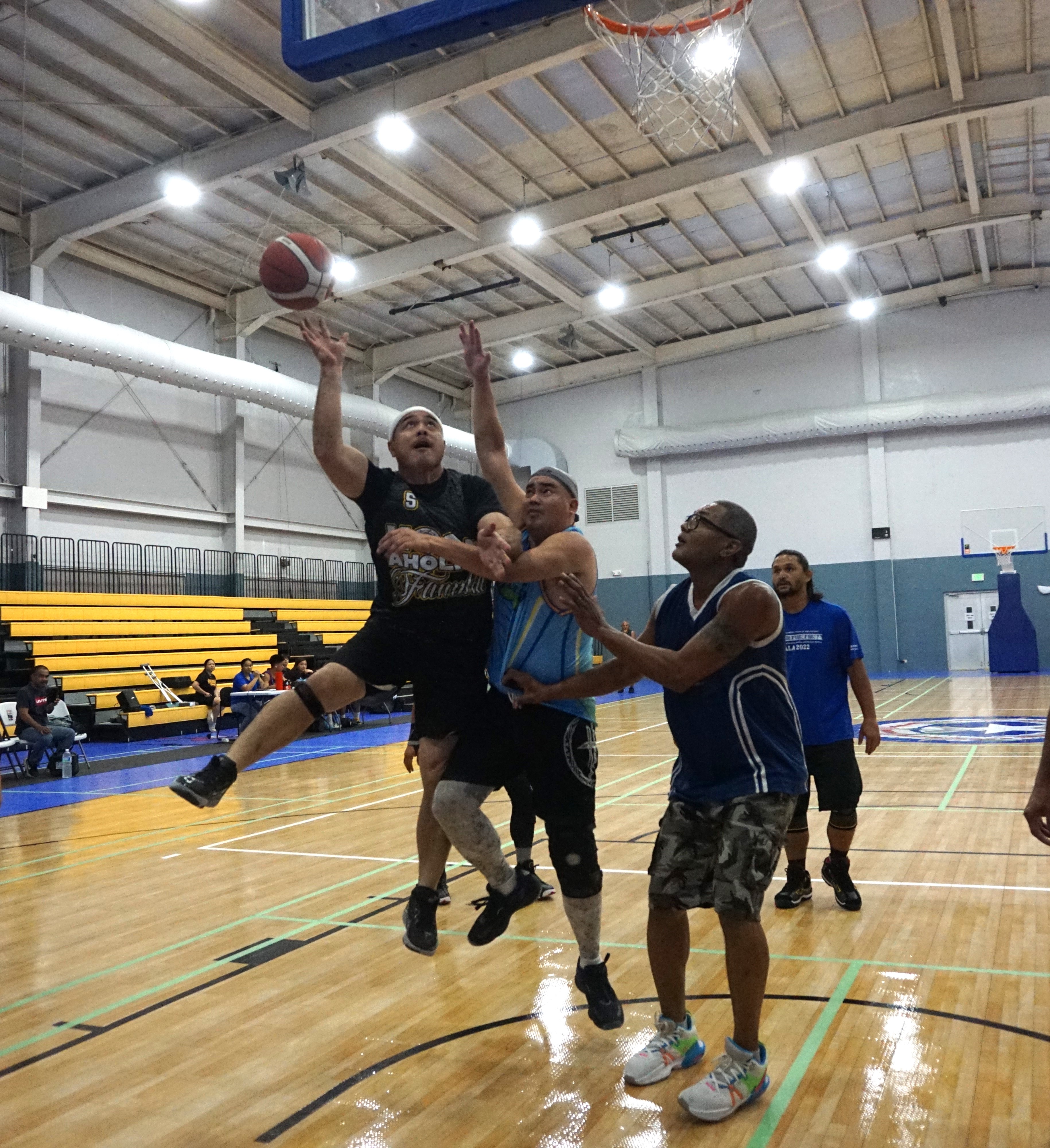 Hoopaholics 670's Henry Sablan gets fouled as he goes up for the layup during a Masters "Internal" Basketball League game at the Ada gym on Saturday. 