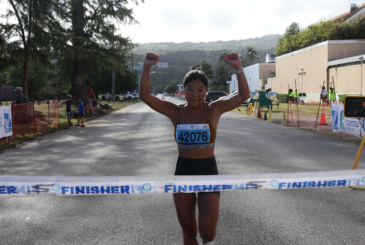 Hana Lee smiles as she reaches the finish line of the Saipan Marathon 2024 at the Micro Beach Saturday morning