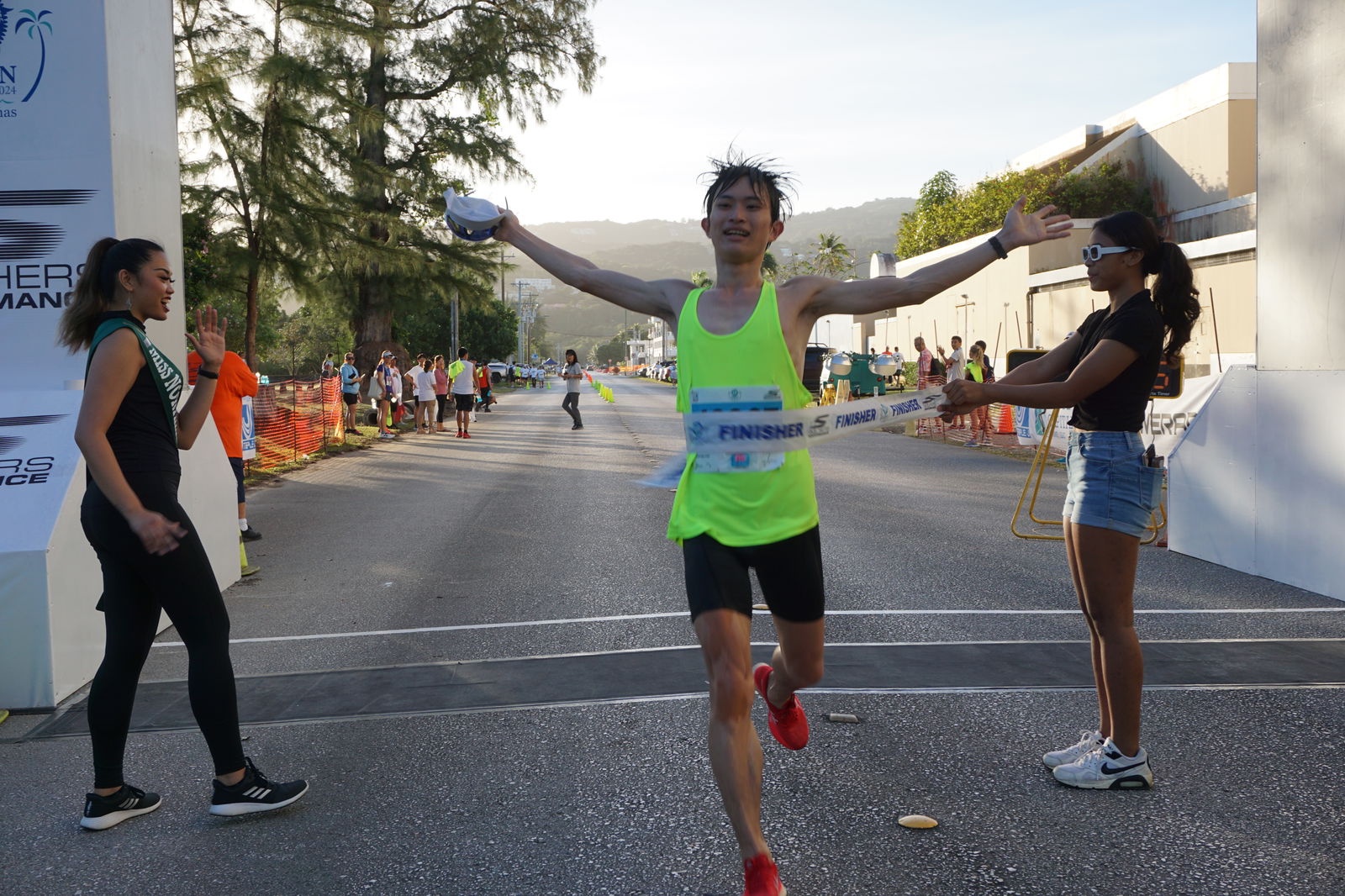 Kaneyama Yuki raises his arms as he crosses the finish line of the Saipan Marathon 2024 at Micro Beach Saturday morning.