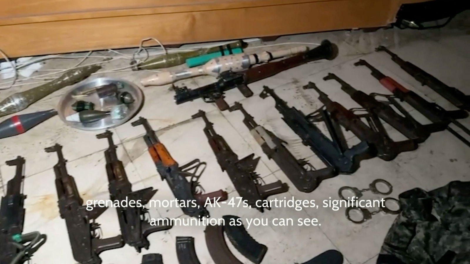 Weapons that the Israeli army says were found in Al Shifa hospital are lined up on the floor, in Gaza city, Gaza, in this screengrab taken from video released on March 20, 2024. 
