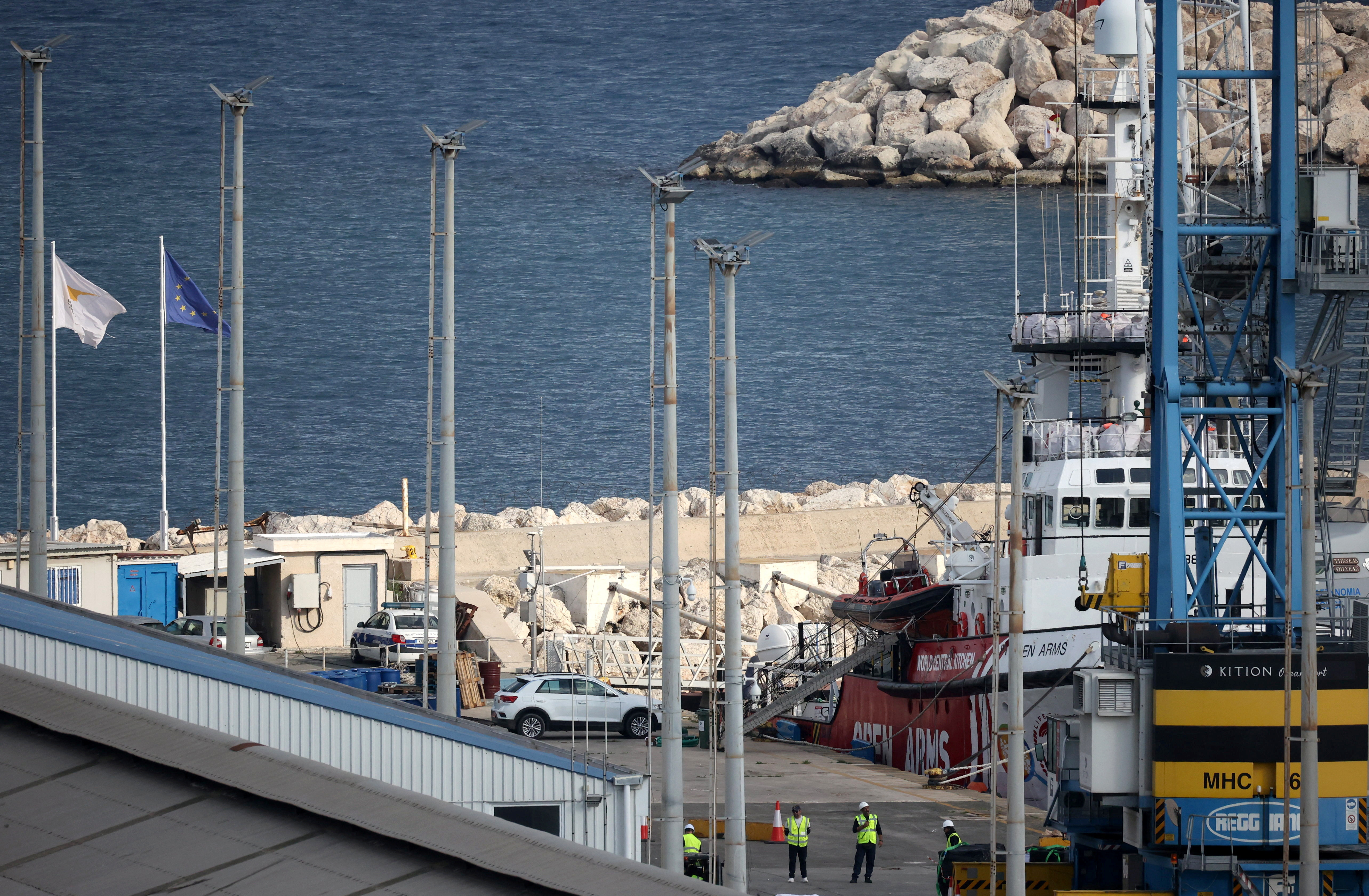 Workers stand near a rescue vessel of the Spanish NGO Open Arms at the port of Larnaca, Cyprus March 9, 2024. 