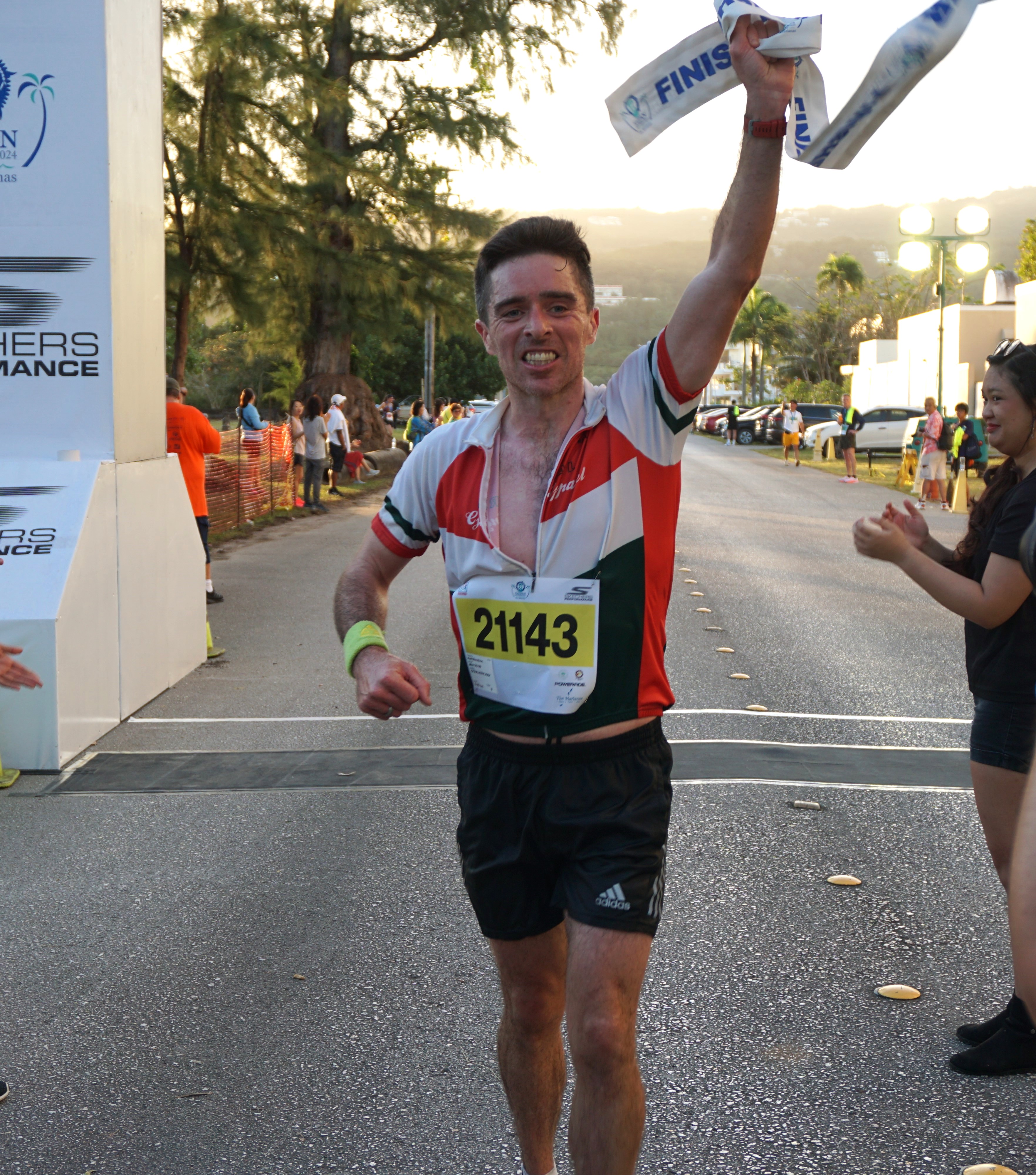 Jody O'Sullivan celebrates after crossing the finish line of the half marathon at  Micro Beach on Saturday.
