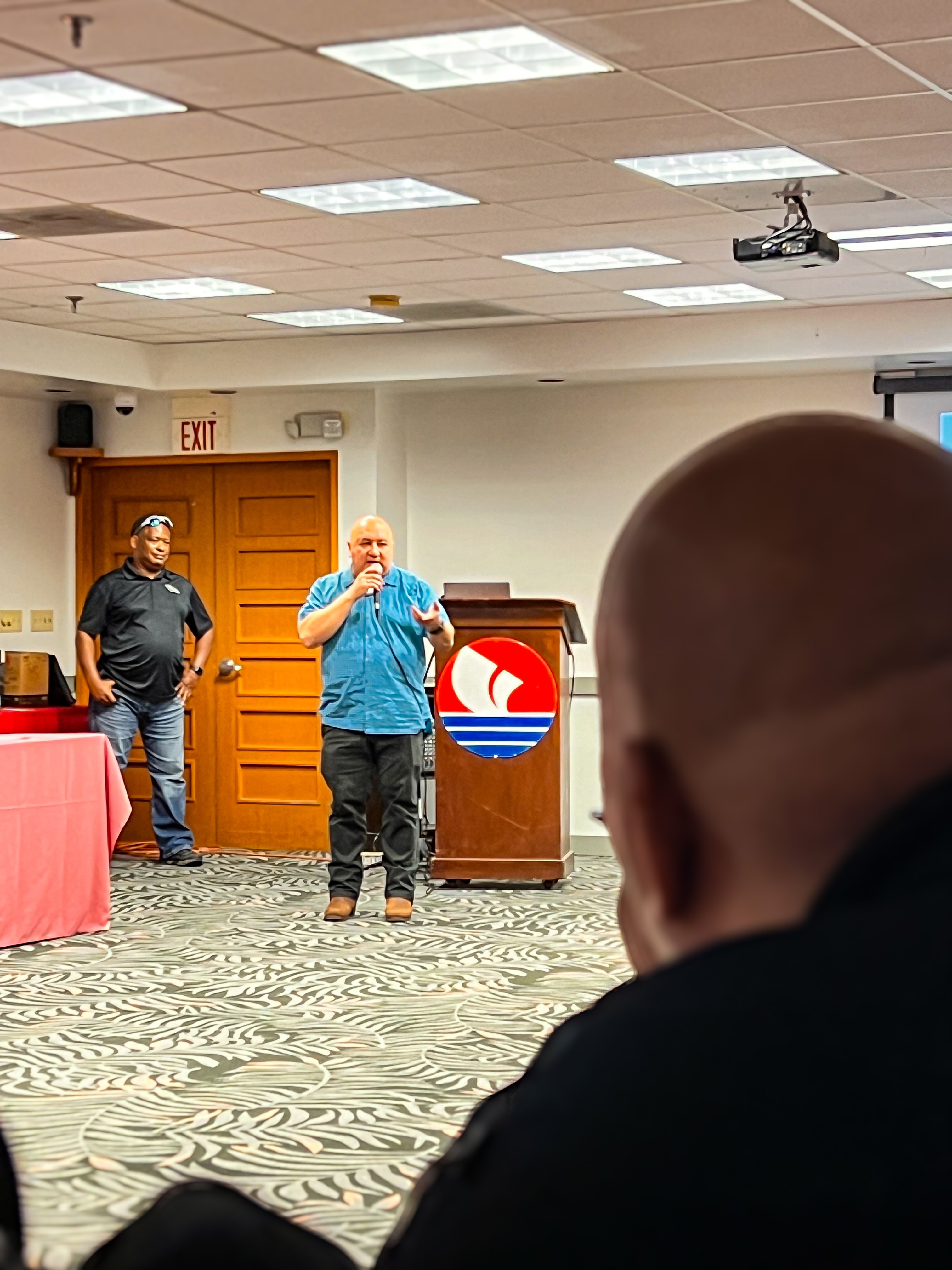 Commissioner of Education Dr. Lawrence F. Camacho talks about the importance of partnership while PSS Crisis Response Manager Anthony Frank listens.