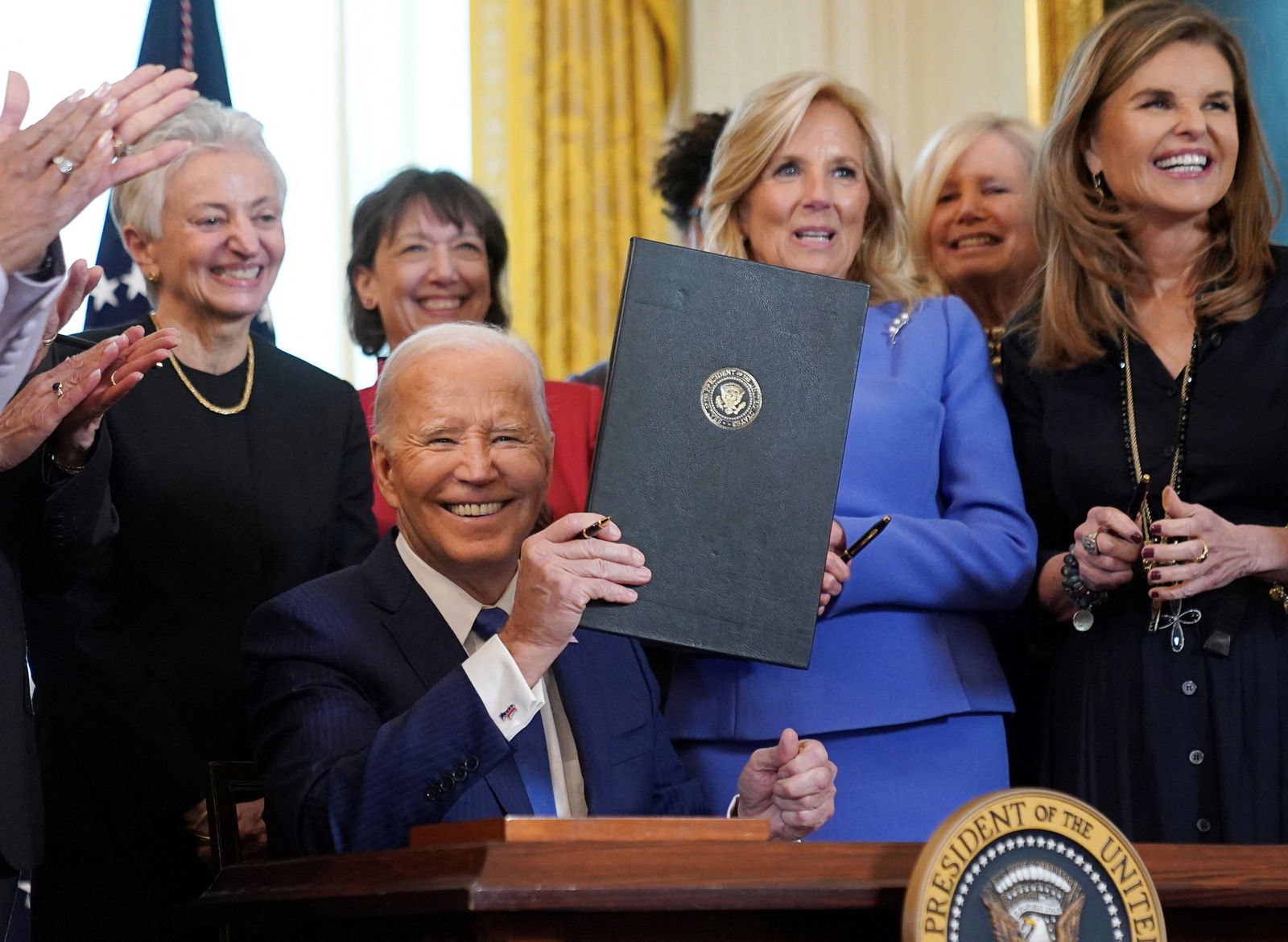 First lady Jill Biden and Maria Shriver smile after U.S. President Joe Biden signed an executive order to expand and improve research on women's health during a Women's History Month reception at the the White House in Washington, U.S., March 18, 2024. 