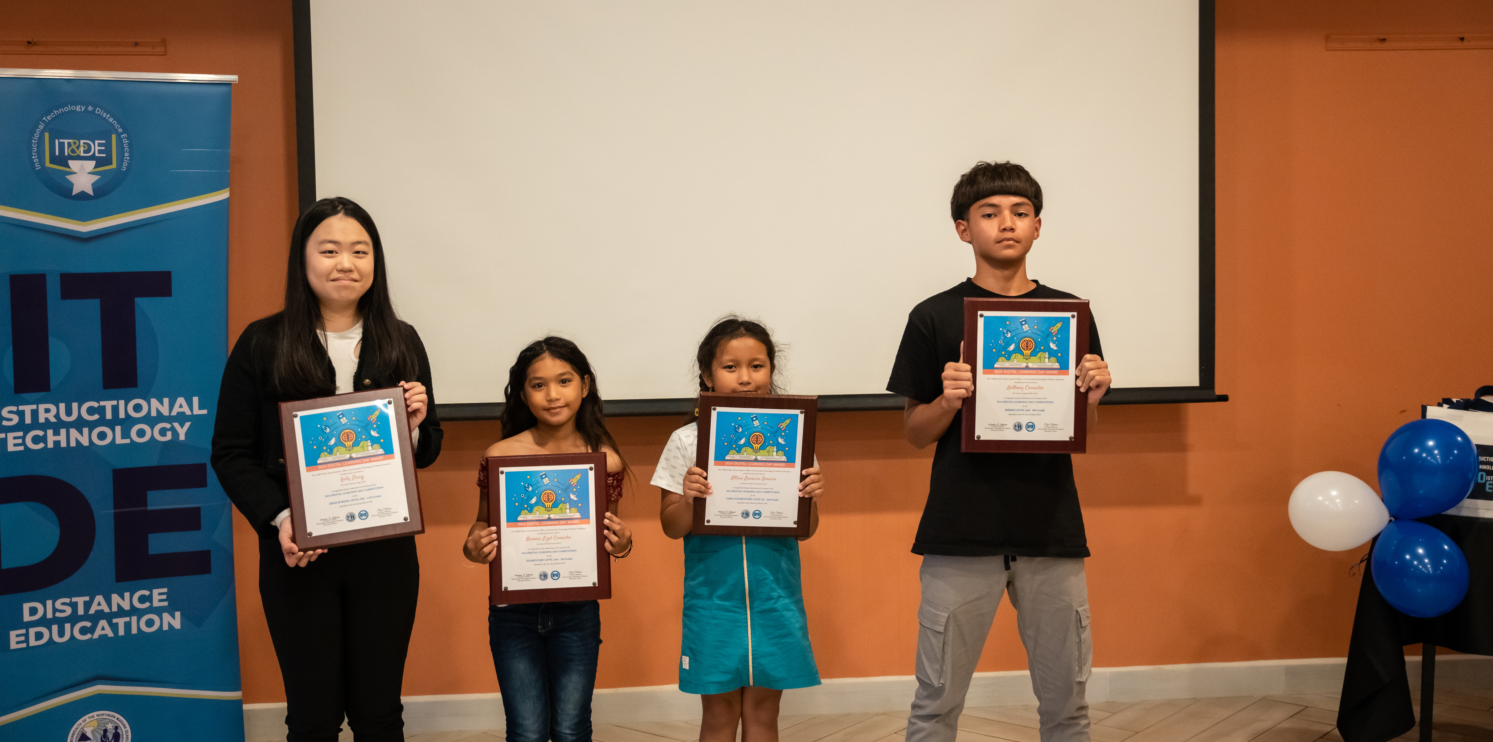 Digital Learning Day awardees: high school winner Kelly Zheng, 11th grader from Marianas High School; elementary school winner Nevonie Camacho, 4th grader from Oleai Elementary School; early elementary school winner Attina Rosario, 2nd grader from Sinapalo Elementary School; and middle school winner Anthony Camacho, 8th grader from Tanapag Middle School.