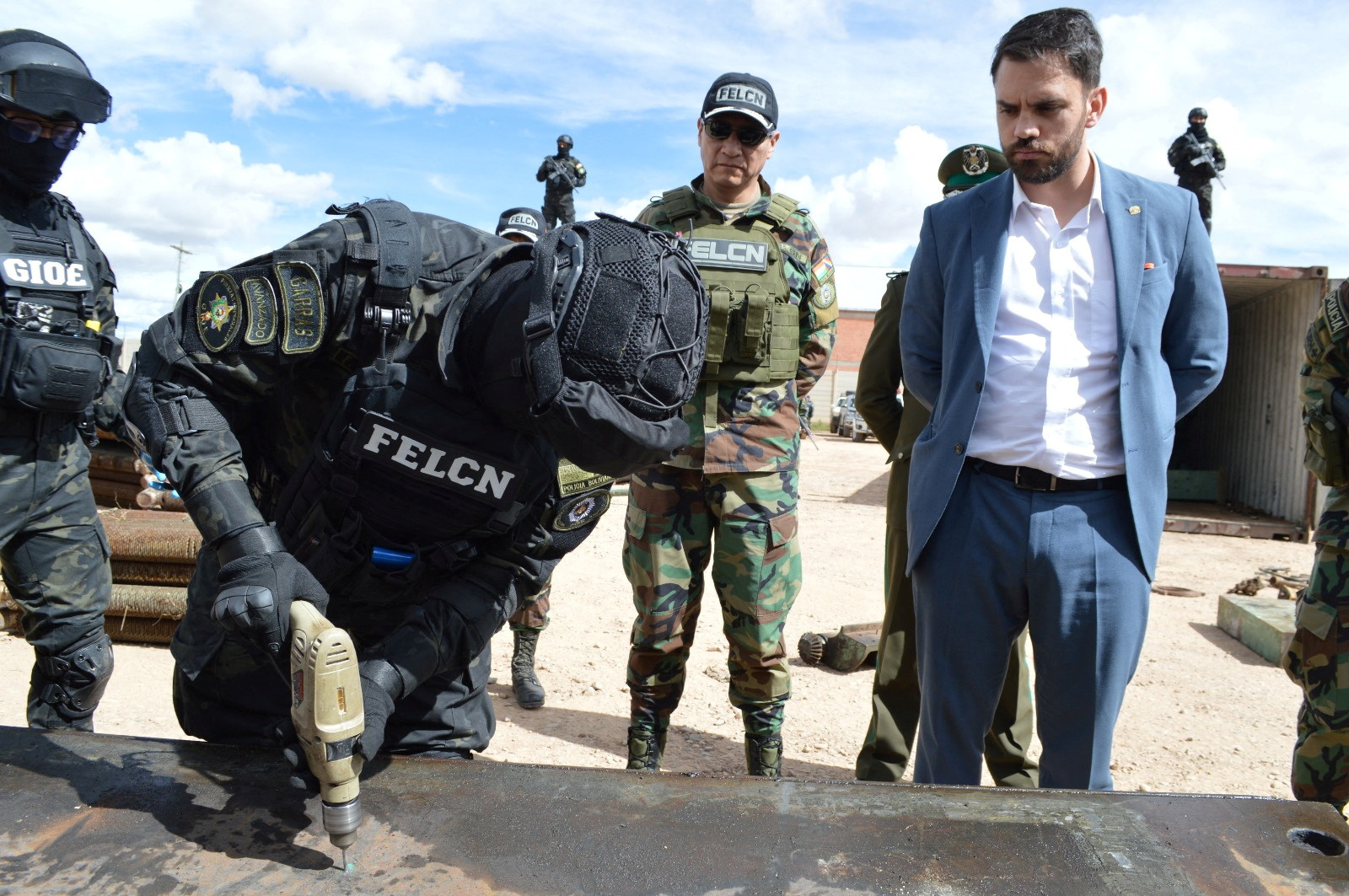 A member of Bolivian security forces checks scrap metal for drug packages after police carried out the second-largest drug bust in the country's history, seizing more than 7.2 tons of cocaine hidden in two trucks transporting scrap iron for export to Europe through Chilean ports on the Pacific, in Oruro, Bolivia, March 19, 2024. 