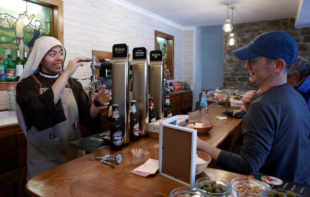 Sister Guadalupe, a nun from the Hermanas Peregrinas de la Eucaristia order, serves drinks at the Amaren Etxea (Mother's House) bar, at the Estibaliz Sanctuary in Villafranca de Estibaliz, northern Spain, March 23, 2024.