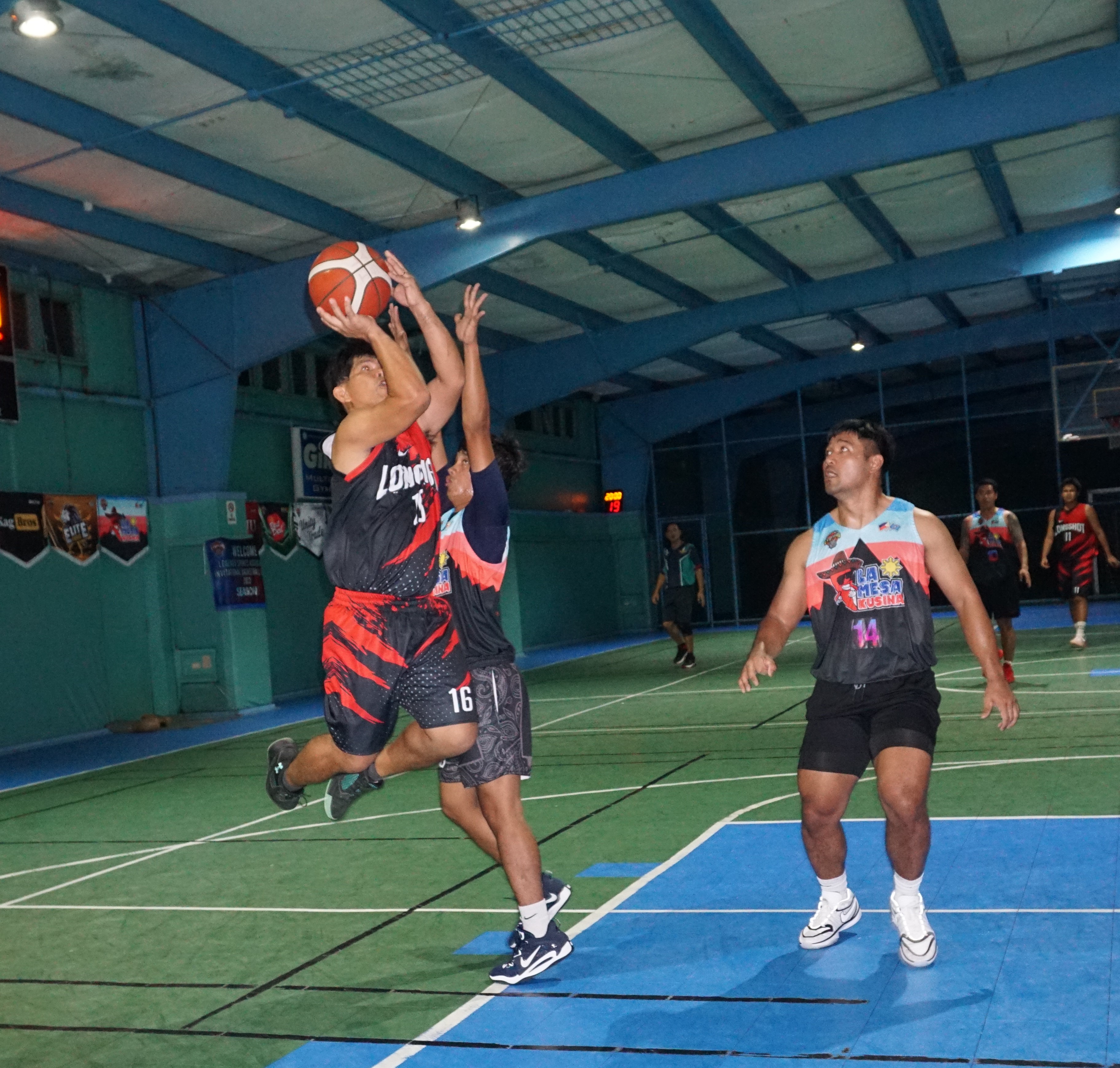 Longshot's Jerry Tolentino gets fouled as he goes up for the shot during a Legends Sports Association Invitational Basketball League Season 2 game at the TSL Sports Complex on Thursday.