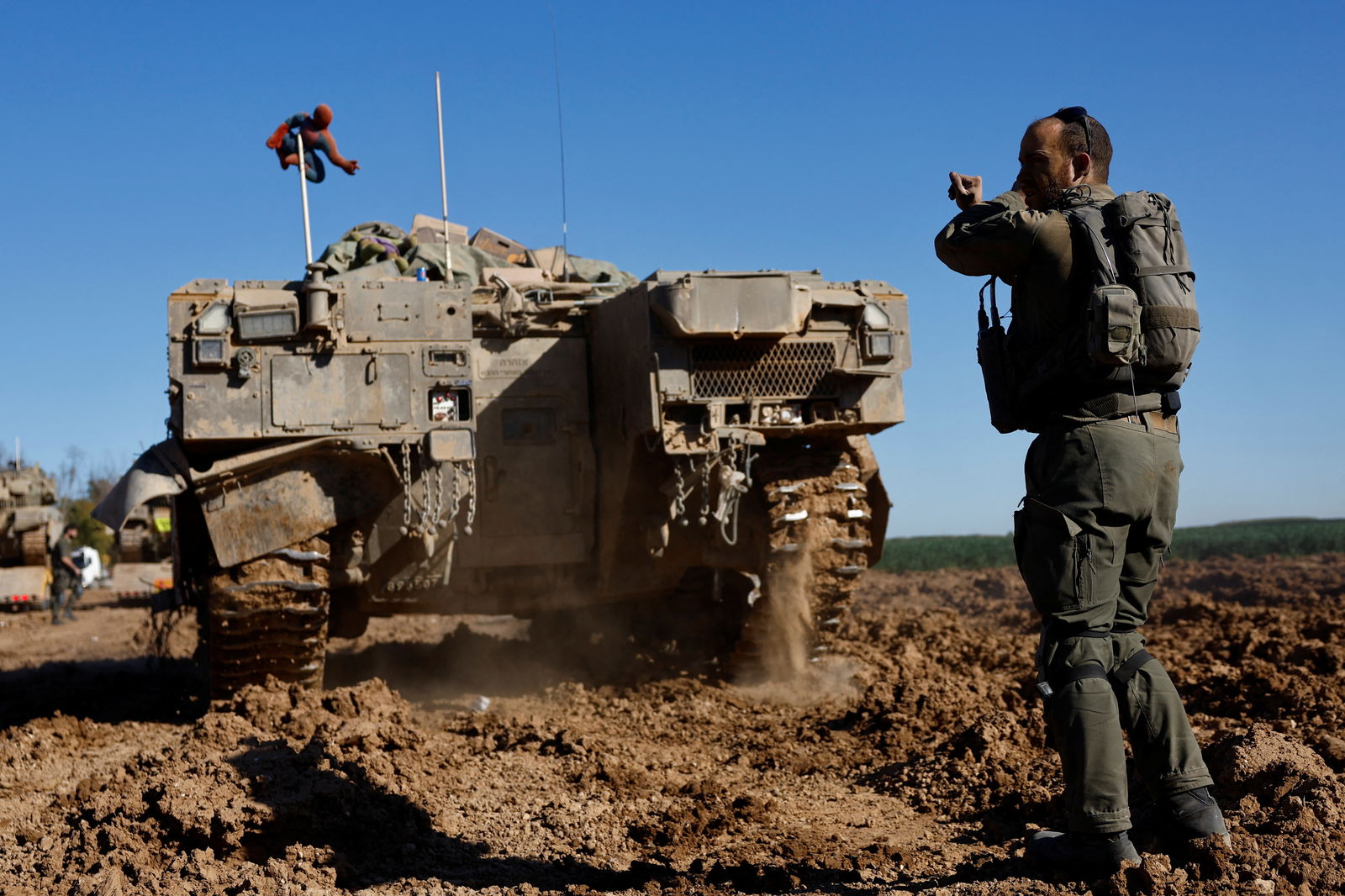 An Israeli soldier stands near a military vehicle after returning from the Gaza strip, amid the ongoing conflict between Israel and Palestinian Islamist group Hamas, in southern Israel, February 29, 2024. 