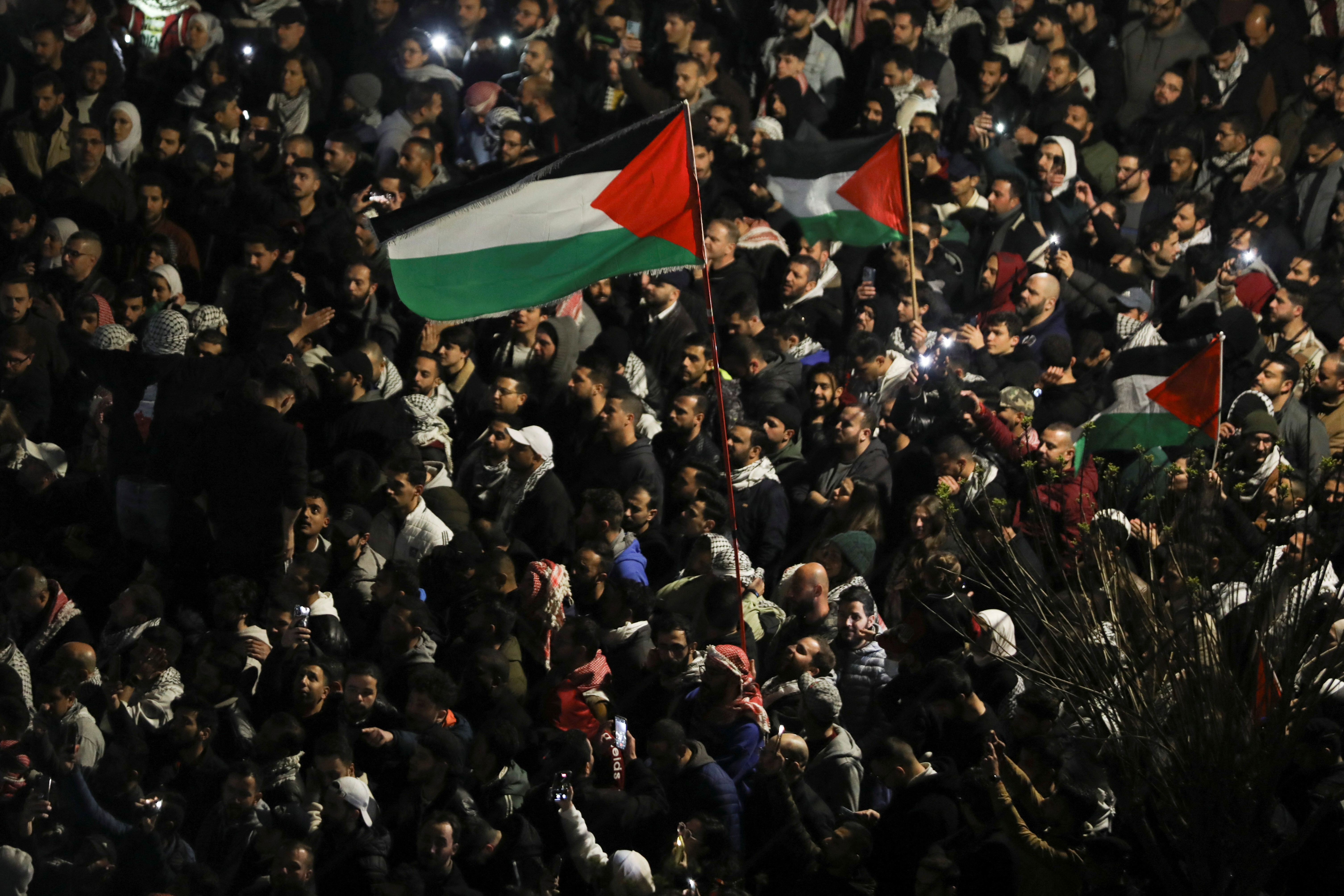 Demonstrators carry flags during a protest in support of Palestinians in Gaza, amid the ongoing conflict between Israel and the Palestinian Islamist group Hamas, outside Al Kalouti mosque near the Israeli embassy in Amman, Jordan, March 26, 2024. 
