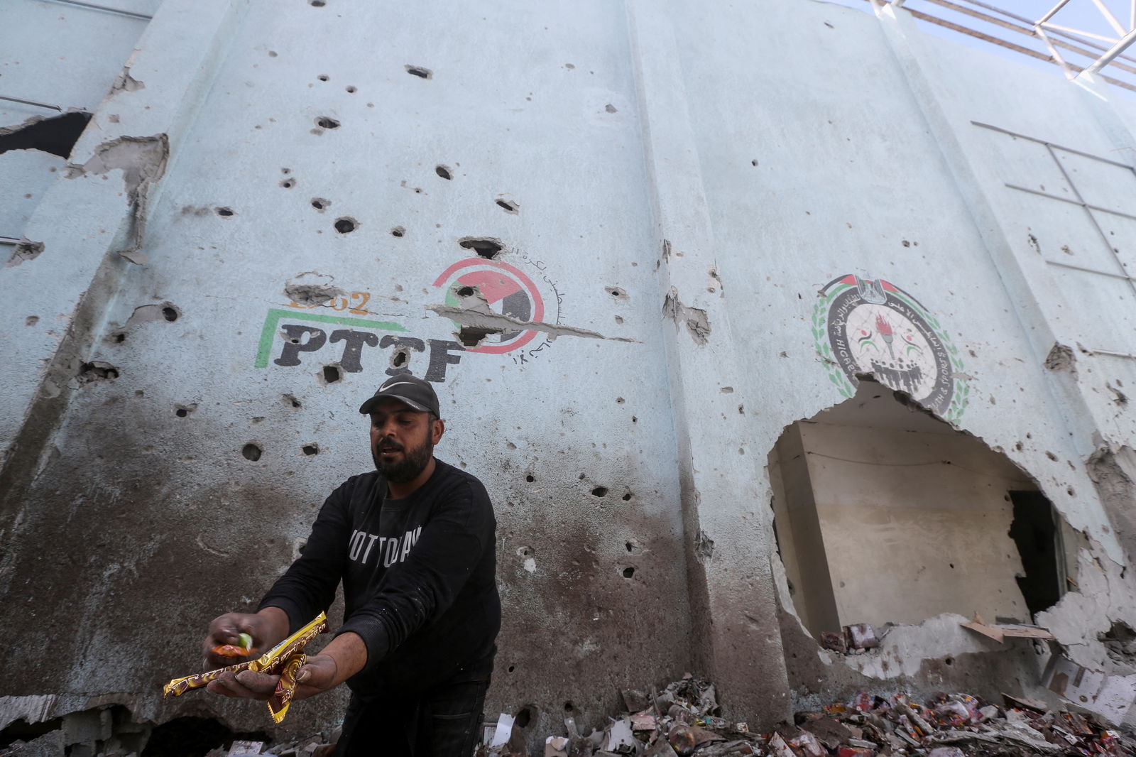 A Palestinian inspects the site of an Israeli strike on an aid warehouse, amid the ongoing conflict between Israel and Hamas, in Al-Nuseirat refugee camp in the central Gaza Strip March 14, 2024. 