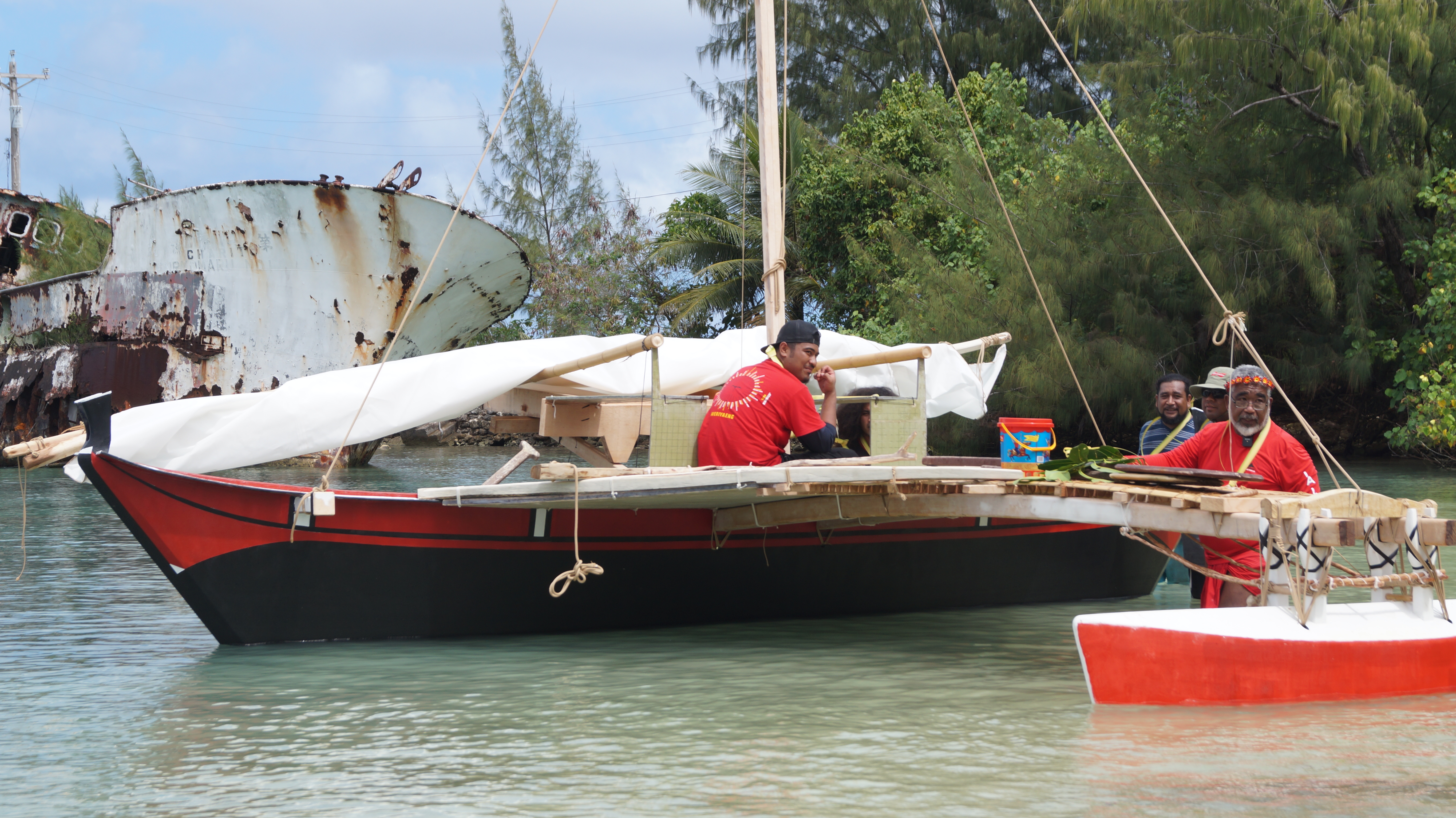 Lolo Benito, left, prepares Mikaela for sailing alongside his father, Master Navigator Mario Benito, right.