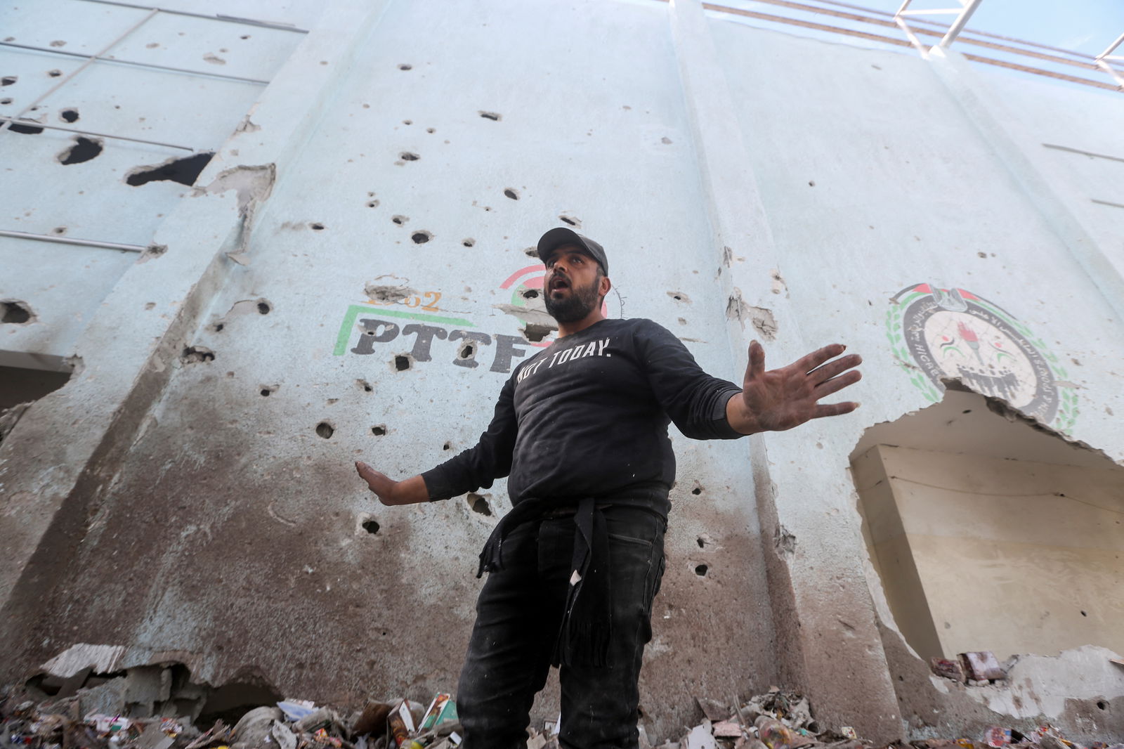 A Palestinian gestures at the site of an Israeli strike on an aid warehouse, amid the ongoing conflict between Israel and Hamas, in Al-Nuseirat refugee camp in the central Gaza Strip March 14, 2024.