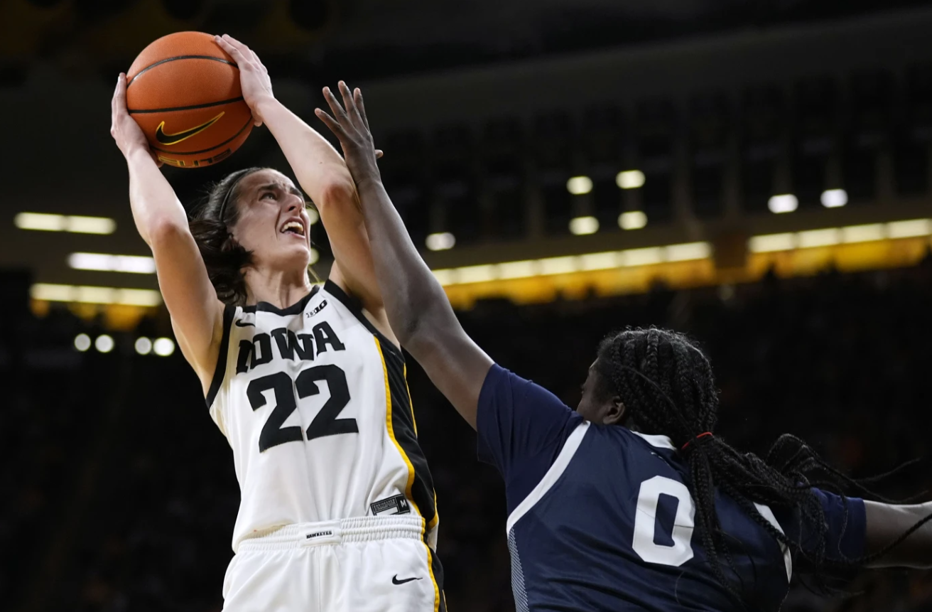 Iowa guard Caitlin Clark (22) is fouled by Penn State guard Ashley Owusu (0) during the first half of an NCAA college basketball game, Feb. 8, 2024 in Iowa City, Iowa.