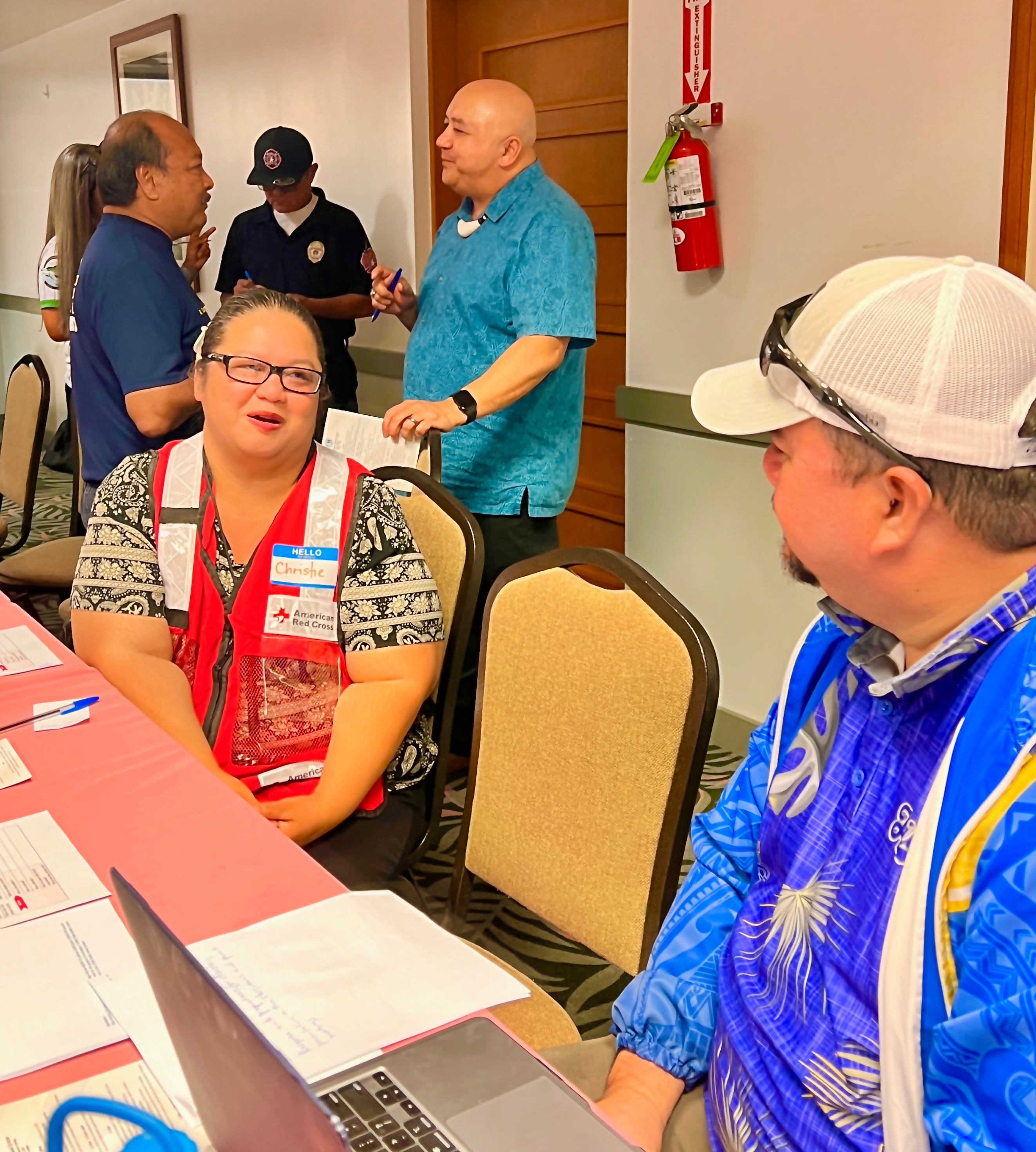 Hopwood Principal Victorino Borja, seated right, listens to American Red Cross-NMI Chapter’s Christine Sablan. Also in photo are Commissioner of Education Dr. Lawrence F. Camacho and DFEMS Deputy Secretary Steve Mesgnon.