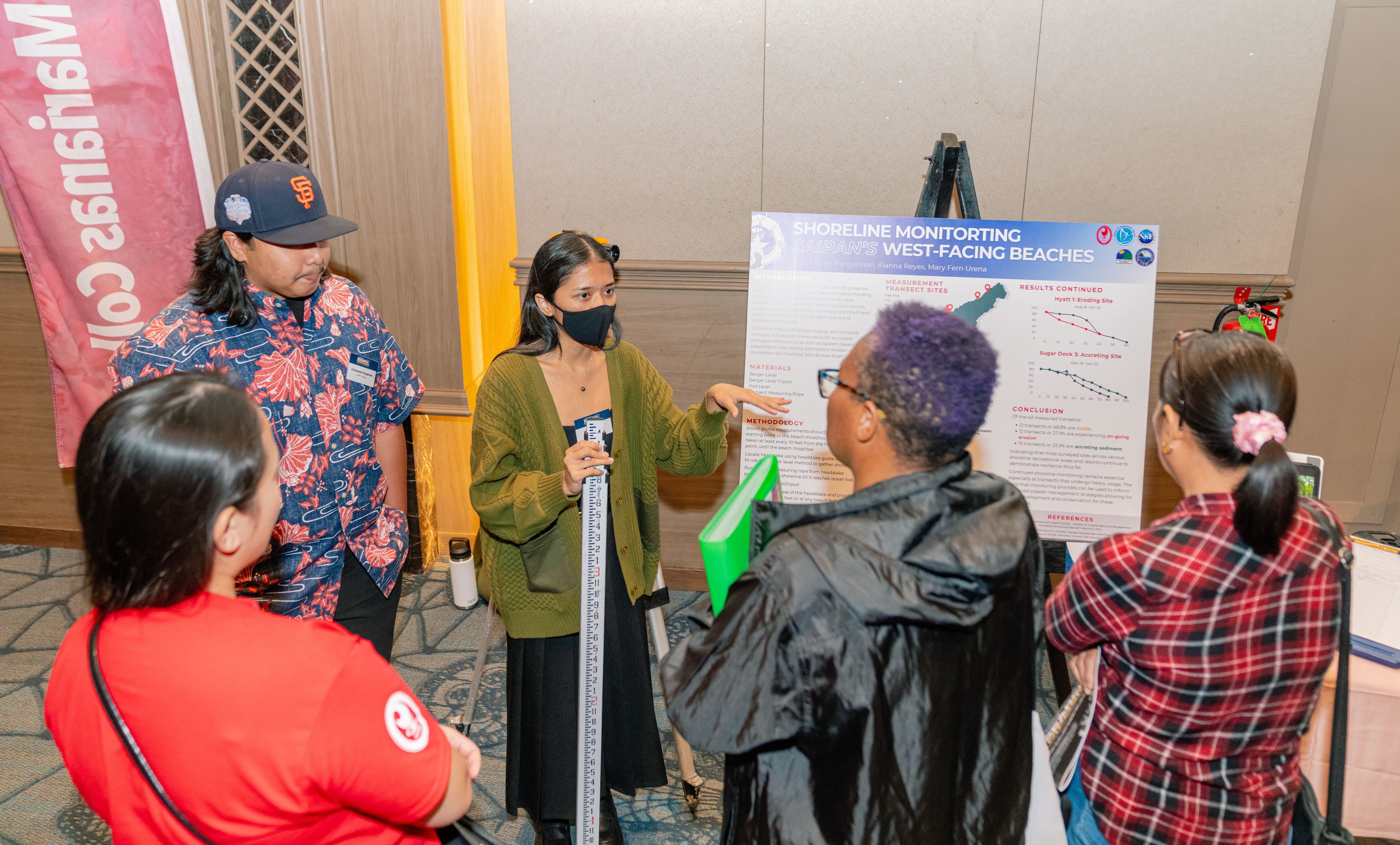 Christopher Pangelinan and Kianna Reyes, NMC students, present their research to symposium attendees.