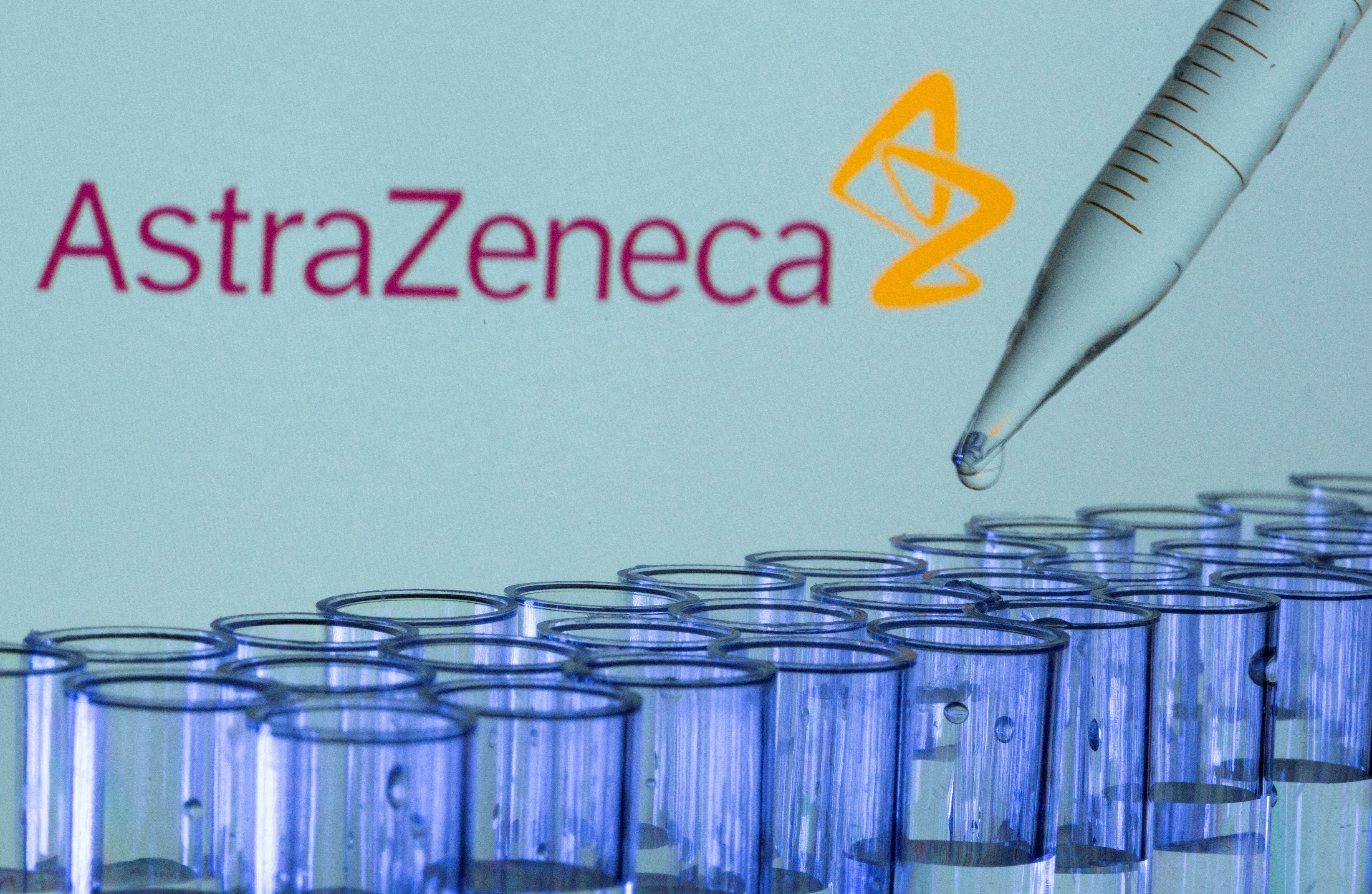 FILE PHOTO: Test tubes are seen in front of a displayed AstraZeneca logo in this illustration taken, May 21, 2021. 