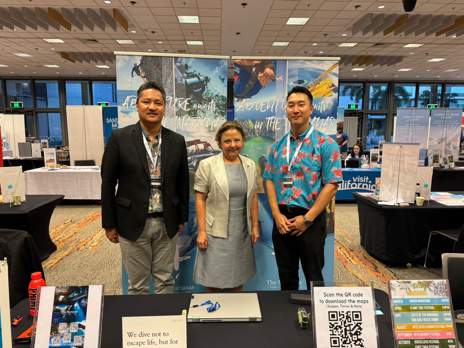 Consul General Christine Elder of the Consulate General in Sydney, Australia, stops by the Marianas promotions table at the Brand USA Australia Road Show on Feb. 20, 2024, in Brisbane. From left, Marianas Visitors Authority Managing Director Christopher A. Concepcion, Elder, and MVA Marketing Manager Thomas Kim.